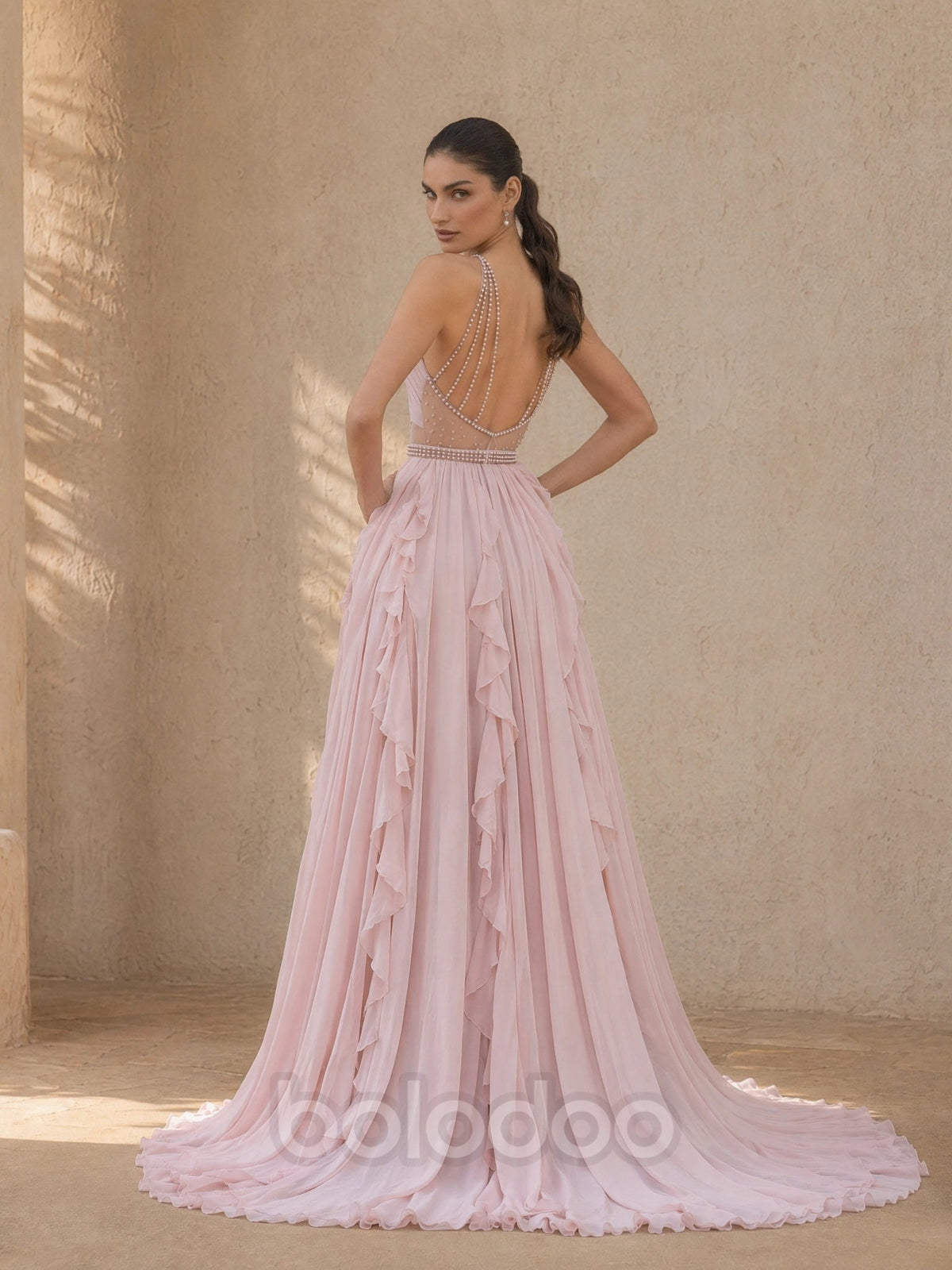 BOLODOO Blush Pink Halter Neck Crossover Keyhole Chiffon Cascading Ruffle Evening Gown - back view pearl chain drape open back with train | BOLODOO watermark