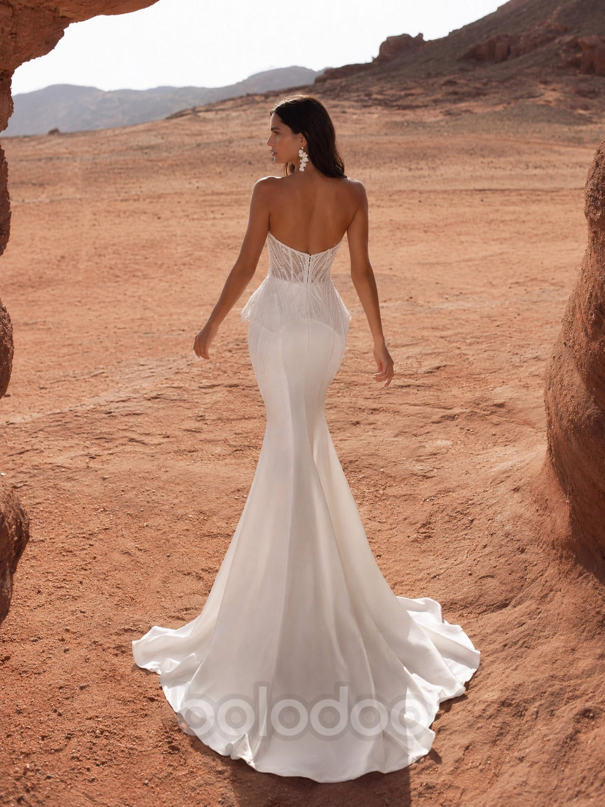 BOLODOO White Radiating Crystal Beaded Sheer Boned Corset Feather Peplum Satin Mermaid Wedding Gown - back view fully open back with sweeping satin train | BOLODOO watermark