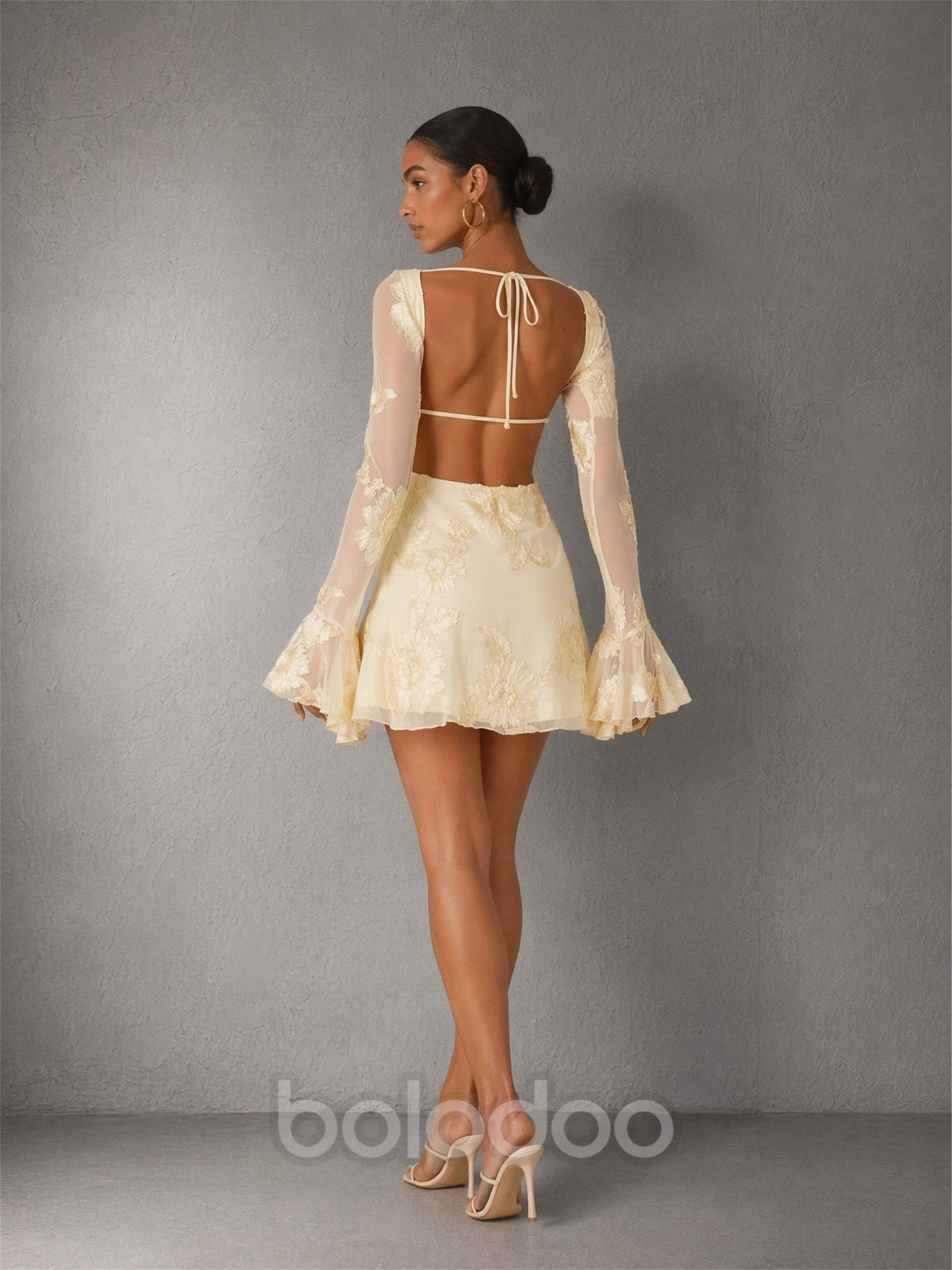 BOLODOO cream 3D floral lace mini dress - front walking view showing bell sleeve movement and floral embroidery texture | BOLODOO watermark