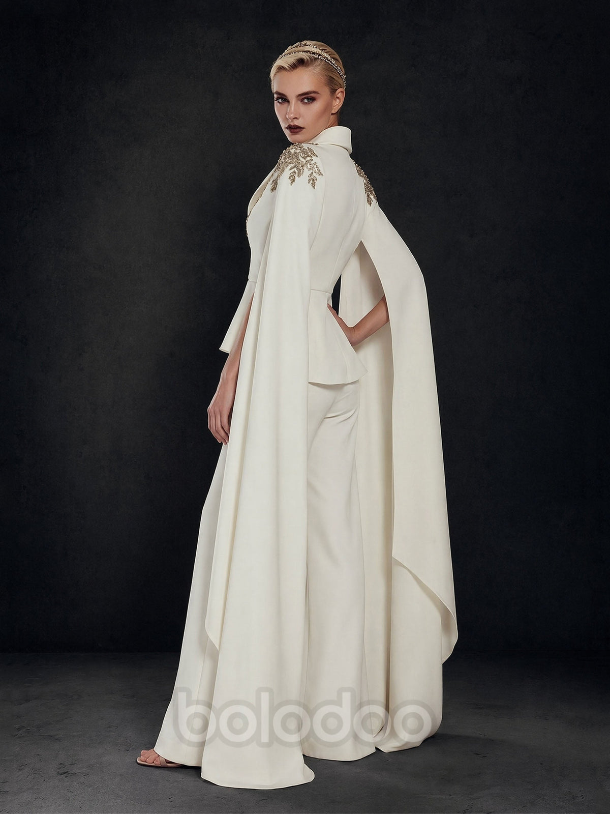 BOLODOO Ivory Gold Leaf Rhinestone Peplum Jumpsuit with Floor-Length Cape - Side Back View Showing Cape Train | BOLODOO watermark