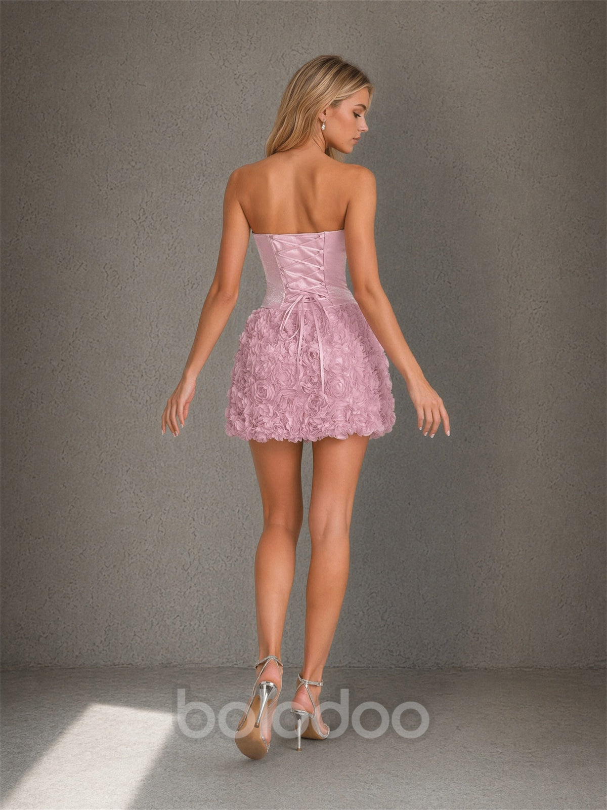 BOLODOO blush pink strapless mini dress lace-up open back detail with ribbon tie and 3D rosette skirt – back view | BOLODOO watermark