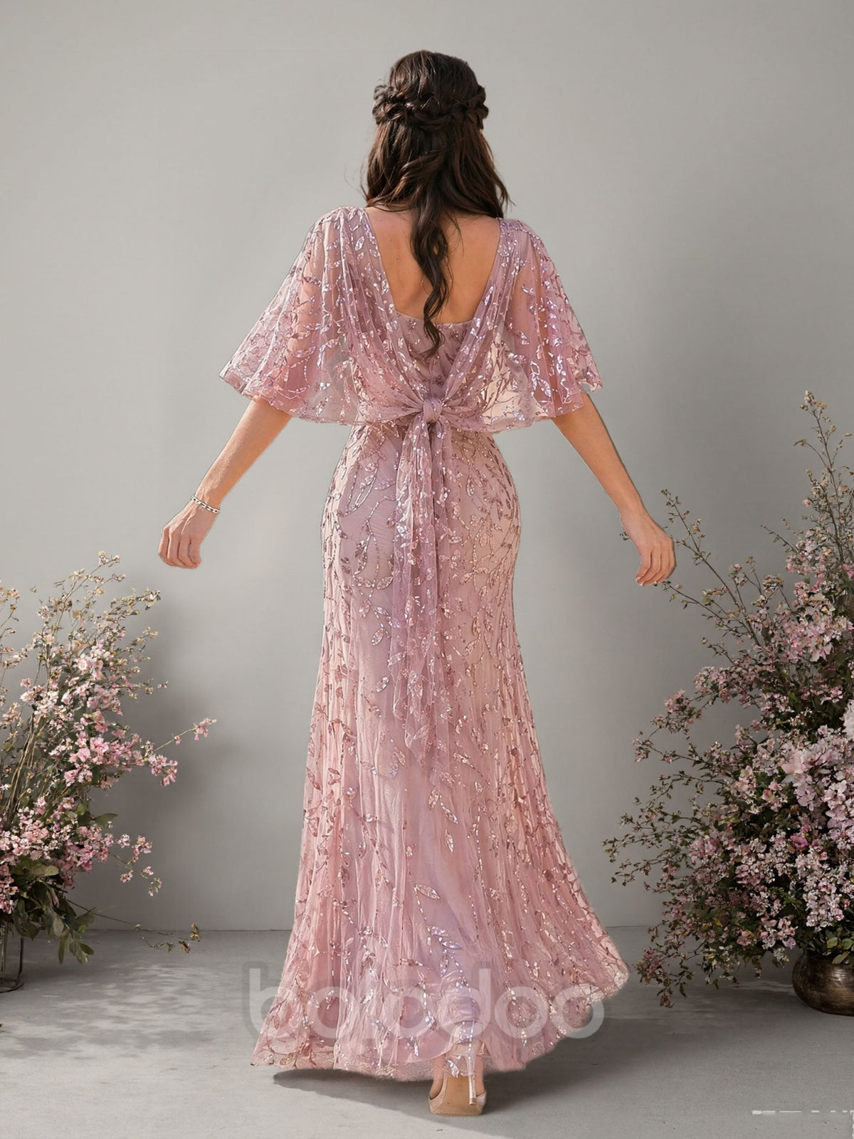 BOLODOO dusty rose sequin floral cape sleeve mermaid evening gown front view looking down showing embroidery detail and floor length hem | BOLODOO watermark