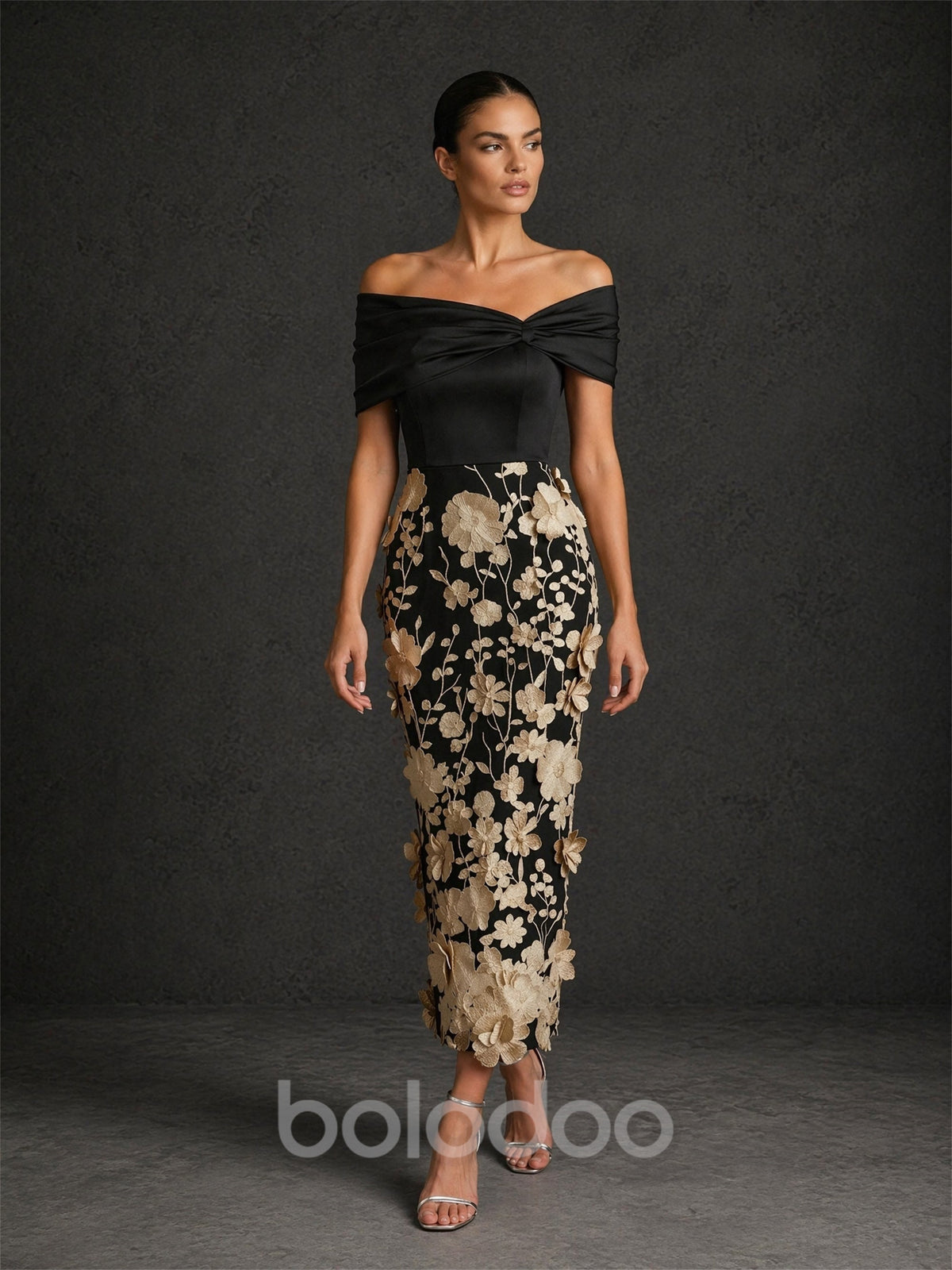 BOLODOO BD0422 black and champagne gold off-shoulder cap sleeve 3D floral appliqué midi dress – second front view highlighting twisted neckline and oversized champagne gold blooms on black mesh skirt | BOLODOO watermark