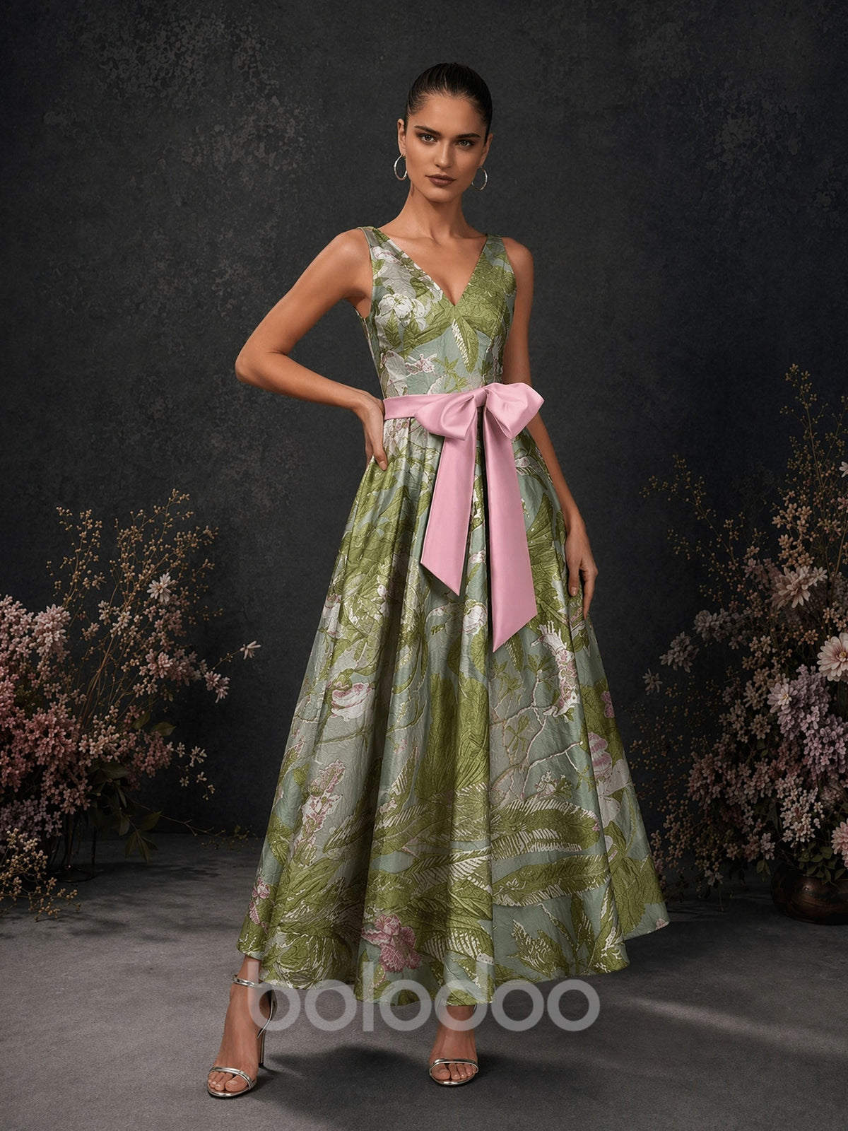 BOLODOO olive green tropical floral jacquard deep V-neck sleeveless A-line tea length dress with pink satin oversized bow belt – front full length hand on hip view | BOLODOO watermark