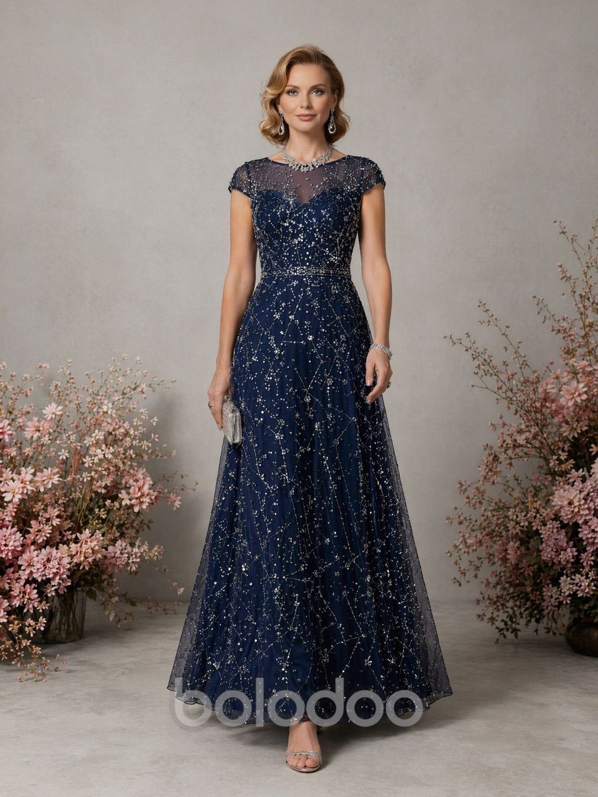 BOLODOO Navy Blue Constellation Sequin Beaded Illusion Bateau Neck Cap Sleeve A-Line Maxi Dress - Front Full Length Relaxed Pose showing Full Skirt | BOLODOO watermark