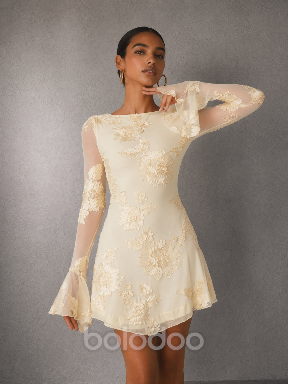 BOLODOO cream long sleeve floral embroidery mini dress - back view showing dramatic open back with tie string closure and bell sleeves | BOLODOO watermark