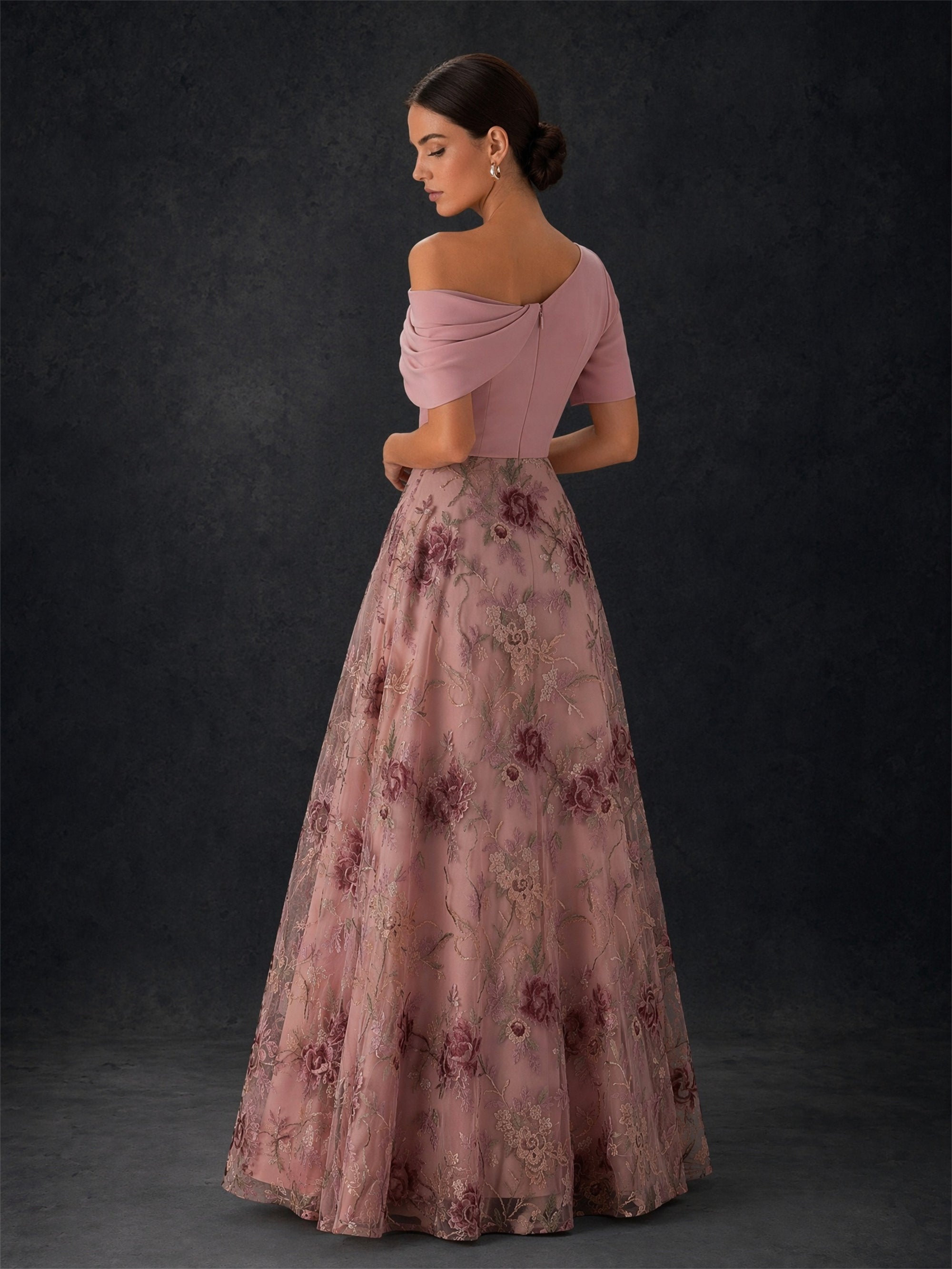 BOLODOO blush pink off-shoulder draped satin gown - front close-up showing asymmetric off-shoulder drape, short sleeve and burgundy rose embroidery detail