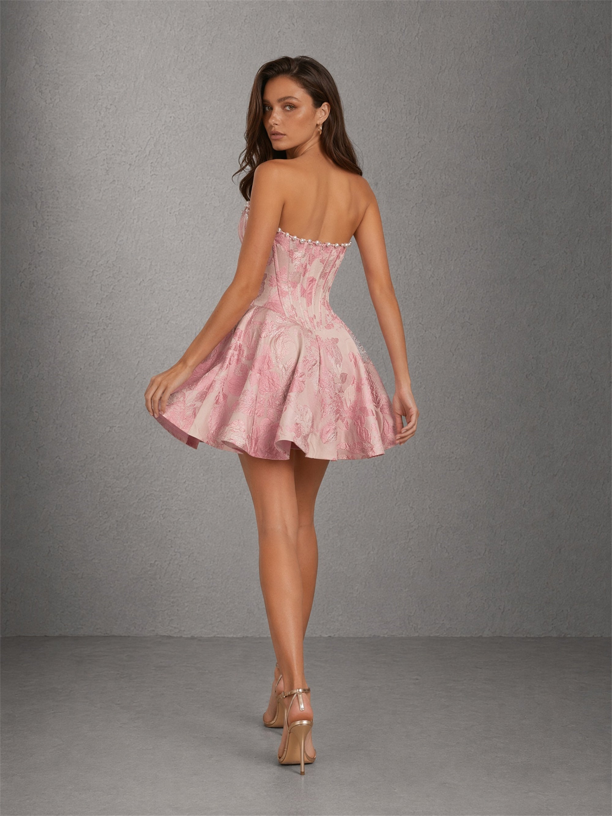 BOLODOO pink jacquard pearl trim strapless sweetheart boned corset fit-and-flare mini dress - front view hands in hair