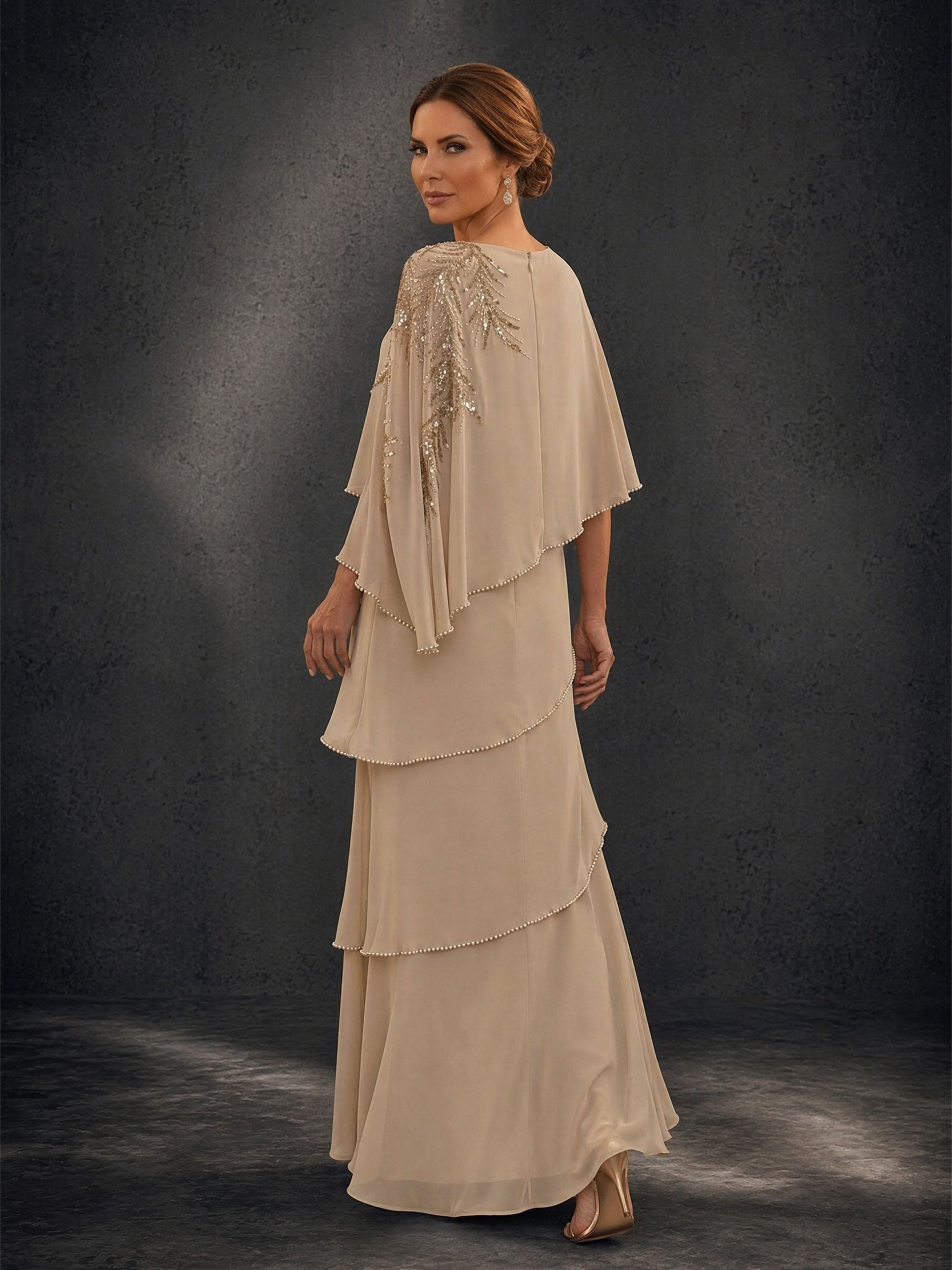 BOLODOO Champagne Mocha Asymmetric Cape Sleeve Gold Sequin Tiered Chiffon Gown – Three-Quarter Back View Showing Cape Drape