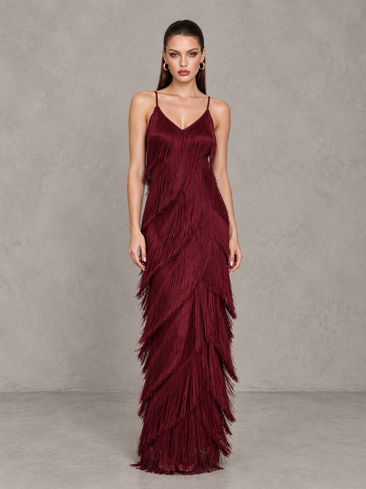 Angled front view of BOLODOO burgundy evening dress with cascading layered fringe