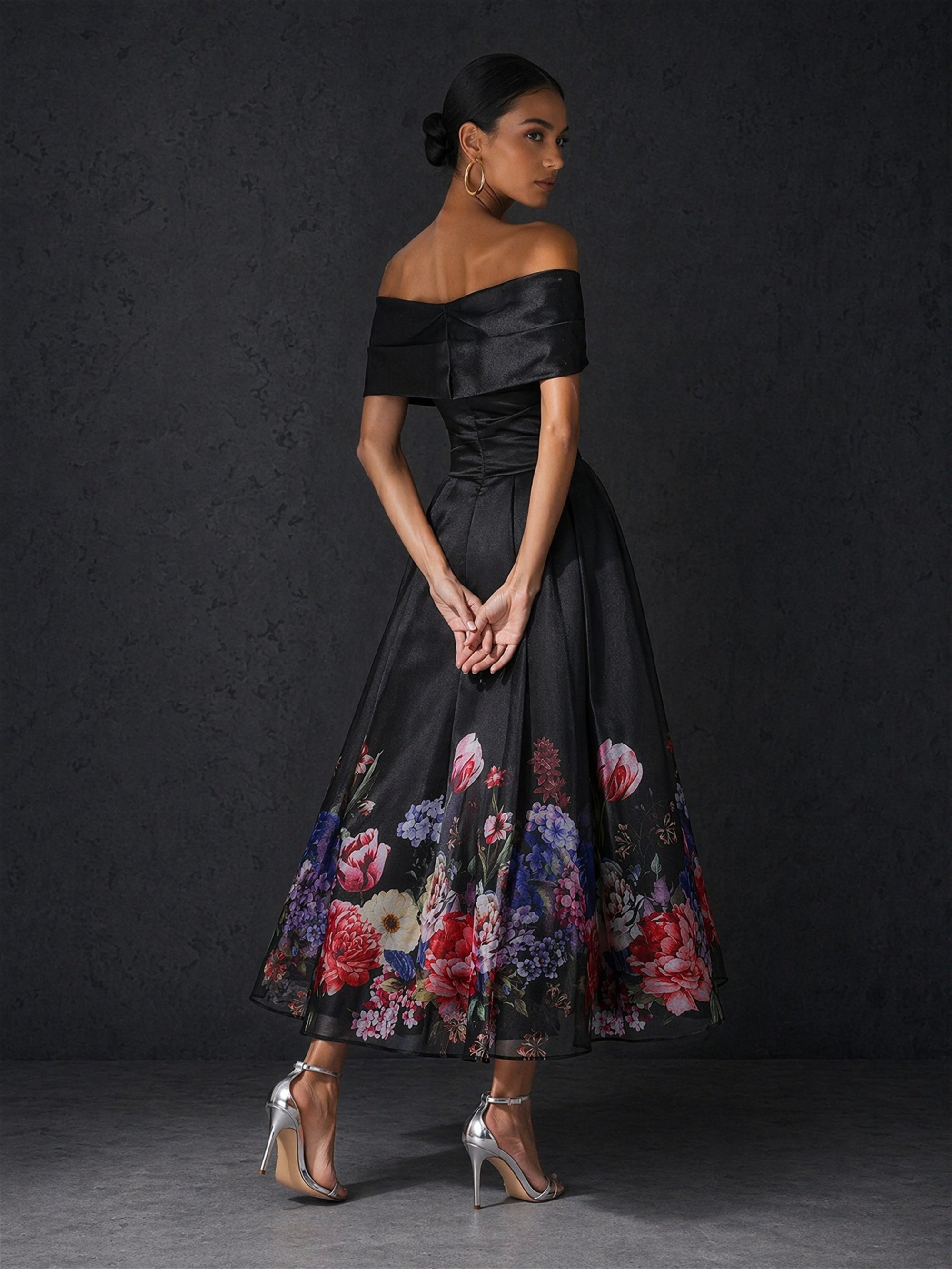 BOLODOO black floral midi dress - front view with black clutch accessory showing full length