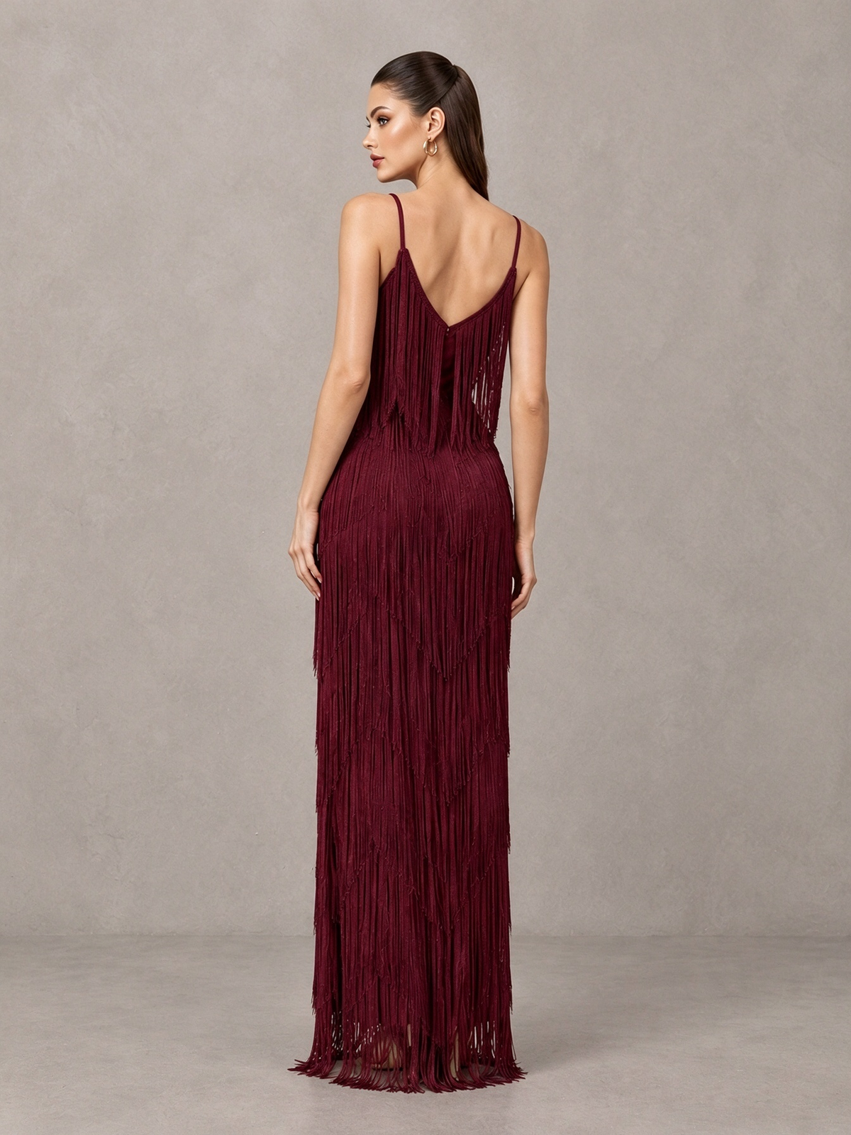 Side view of BOLODOO burgundy sleeveless floor-length fringe formal dress