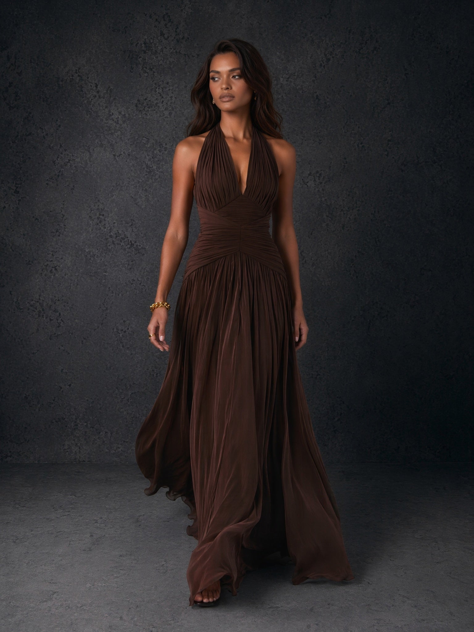 BOLODOO chocolate brown chiffon halter deep V-neck ruched A-line backless maxi dress - front view walking pose with train