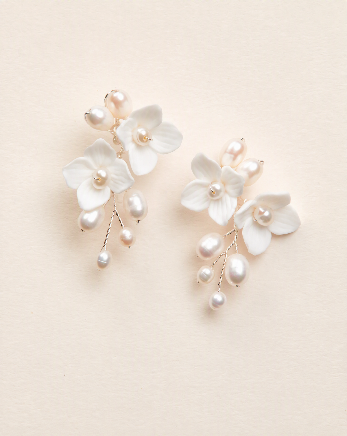 BOLODOO XCD015 ivory floral drop earrings with pearl-look accents and gold-tone branches on a plain background