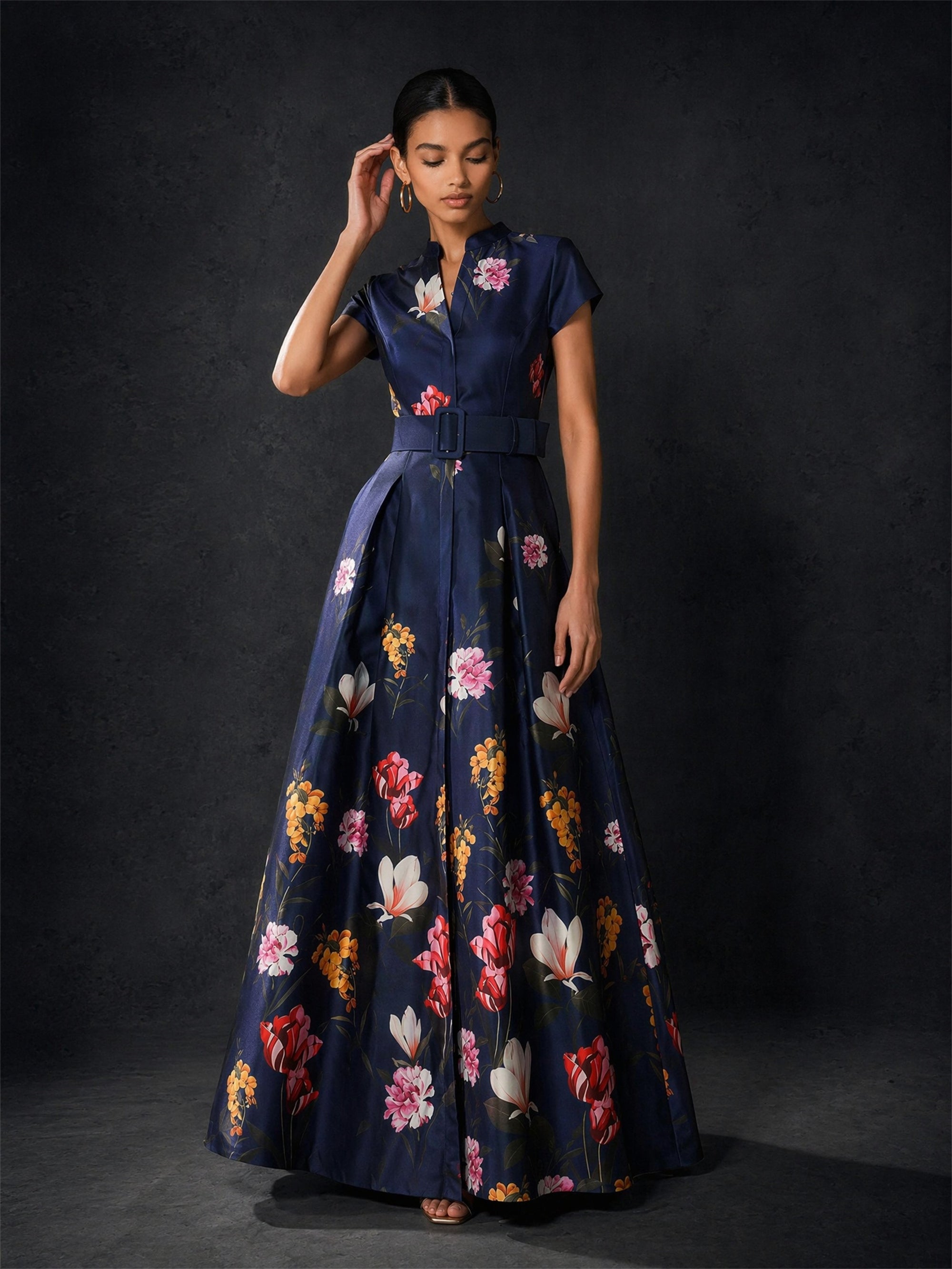 BOLODOO navy floral maxi gown - front view with hand raised showing structured collar and belted waist detail