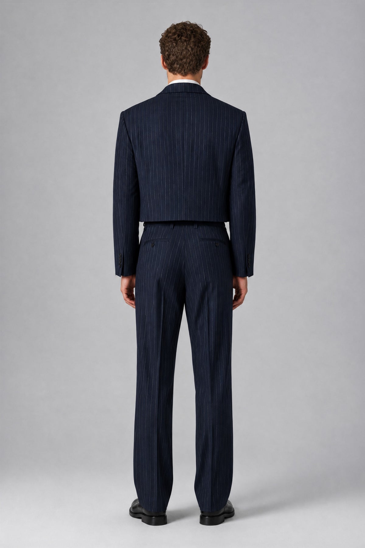 Back view of Bolodoo FQ1021 men's navy pinstripe cropped jacket and matching full-length trousers