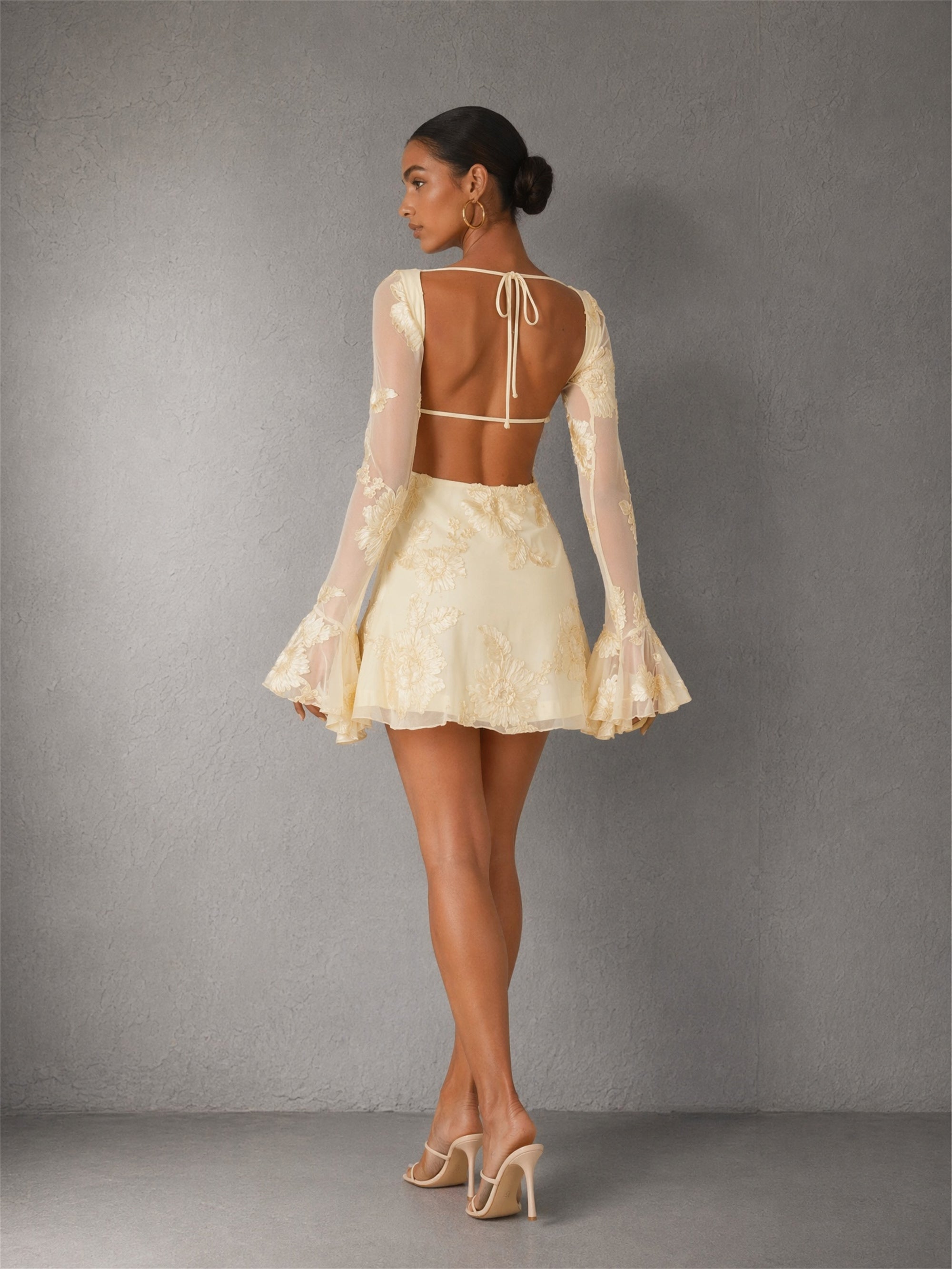 BOLODOO cream 3D floral lace mini dress - front walking view showing bell sleeve movement and floral embroidery texture
