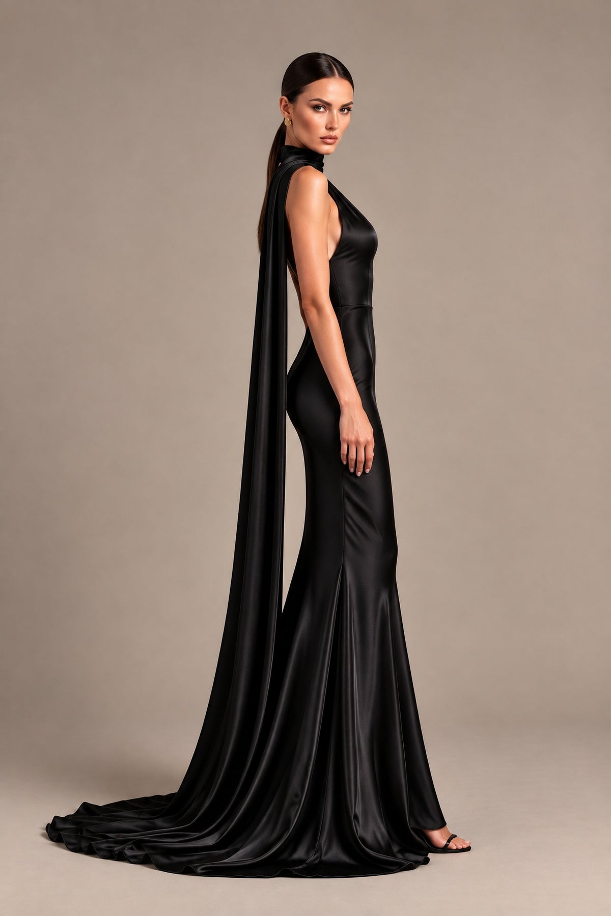 Side view of BOLODOO black floor-length mermaid dress with flowing neck scarf