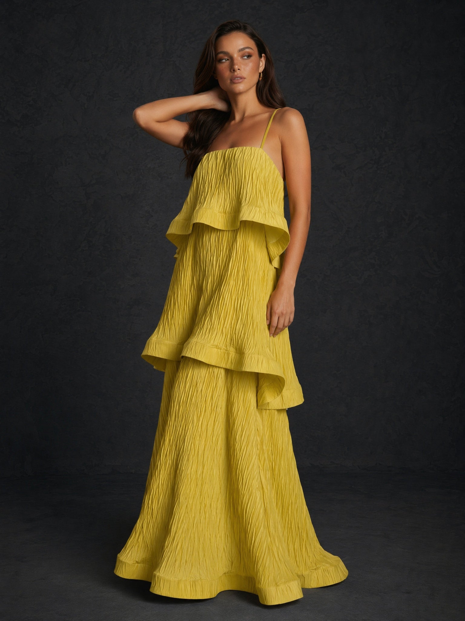 BOLODOO chartreuse yellow crinkle spaghetti strap tiered ruffle A-line backless maxi dress - front three-quarter view arm raised