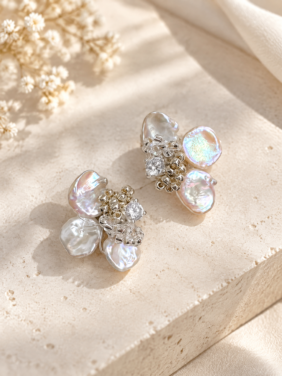 BOLODOO pearl-look floral cluster earrings styled in an open jewelry display box