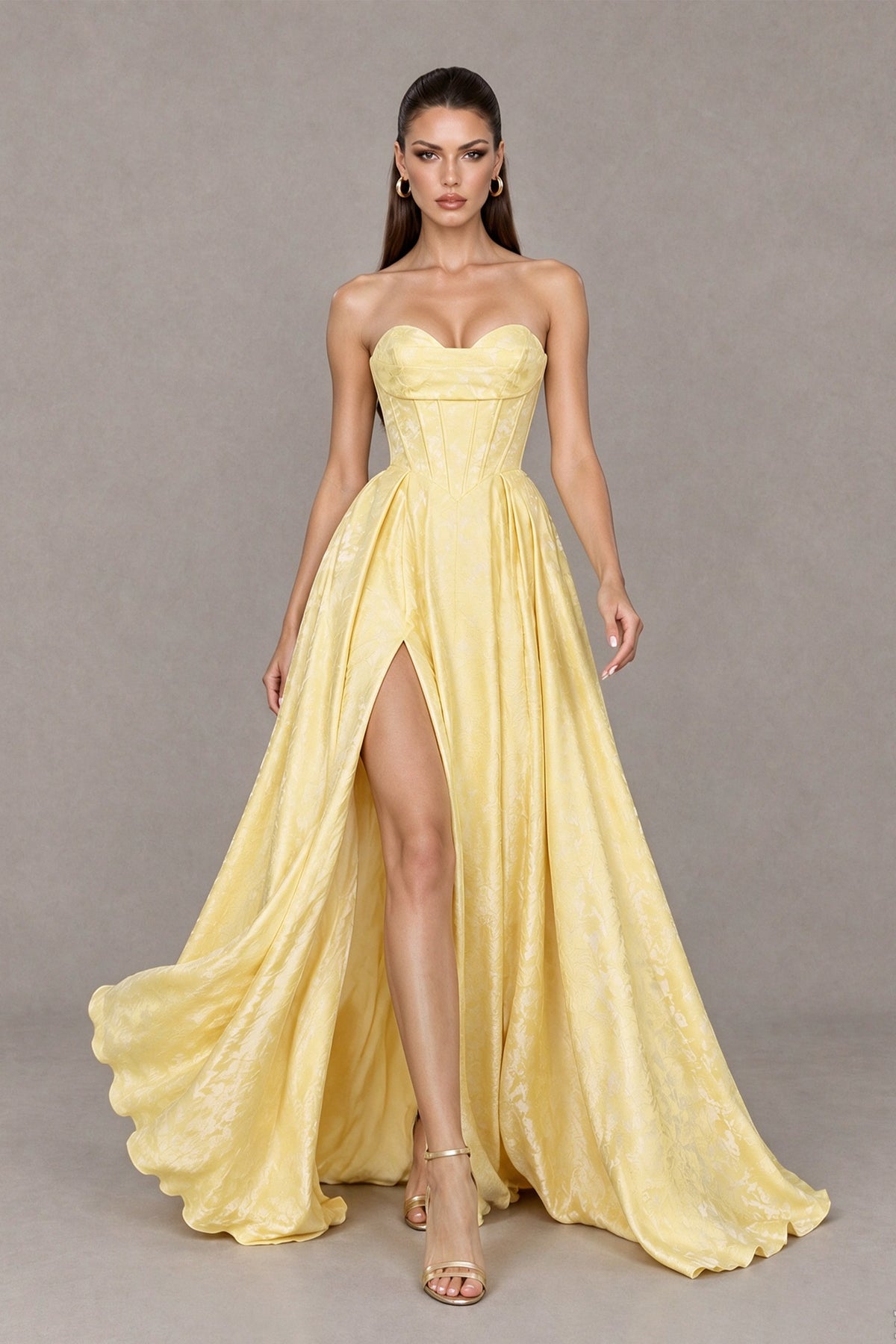BOLODOO yellow satin prom gown with corset bodice and flowing high-slit skirt, front walking view