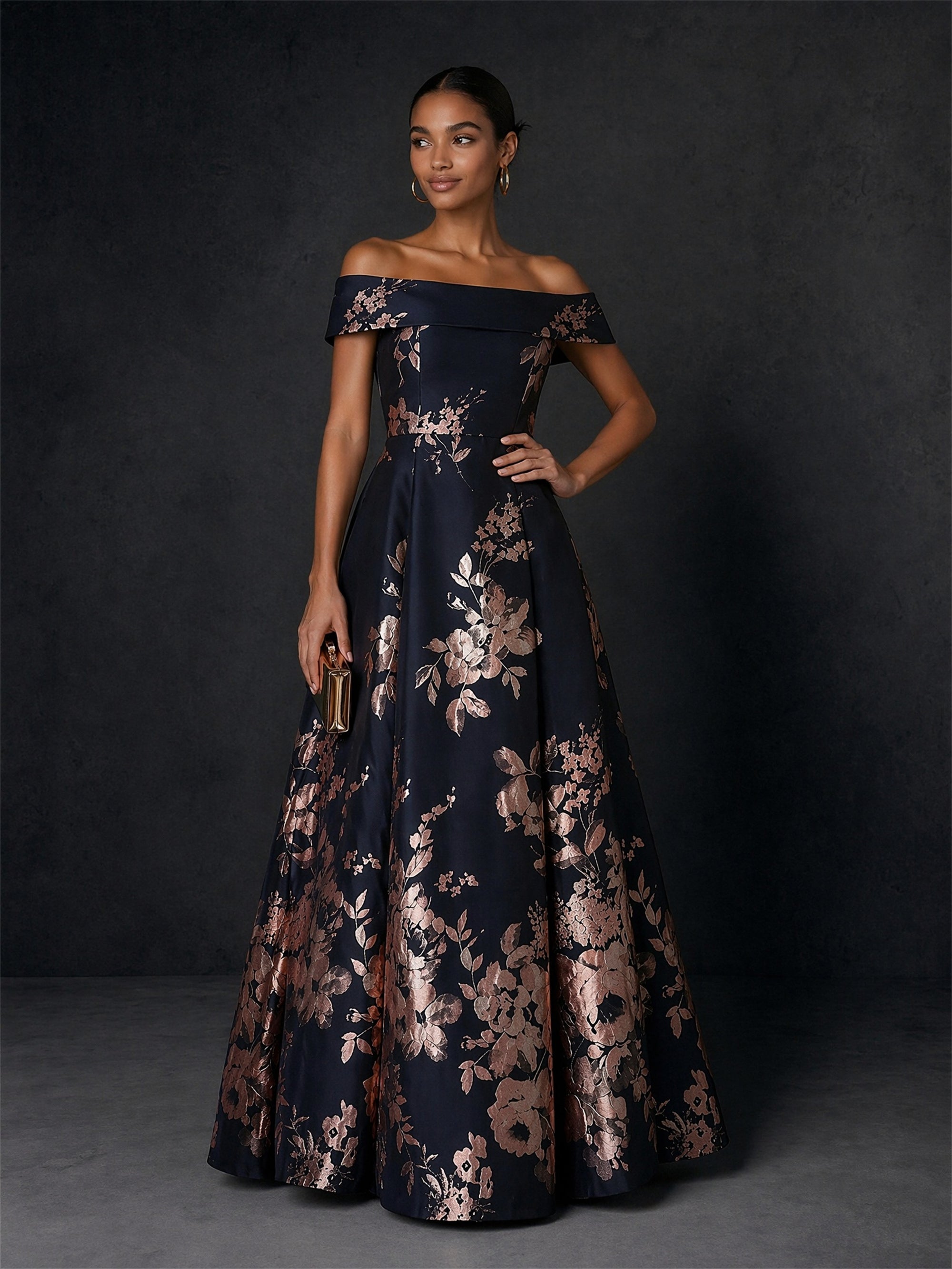 BOLODOO navy rose gold jacquard ball gown - front view with gold clutch showing structured bardot neckline and full skirt
