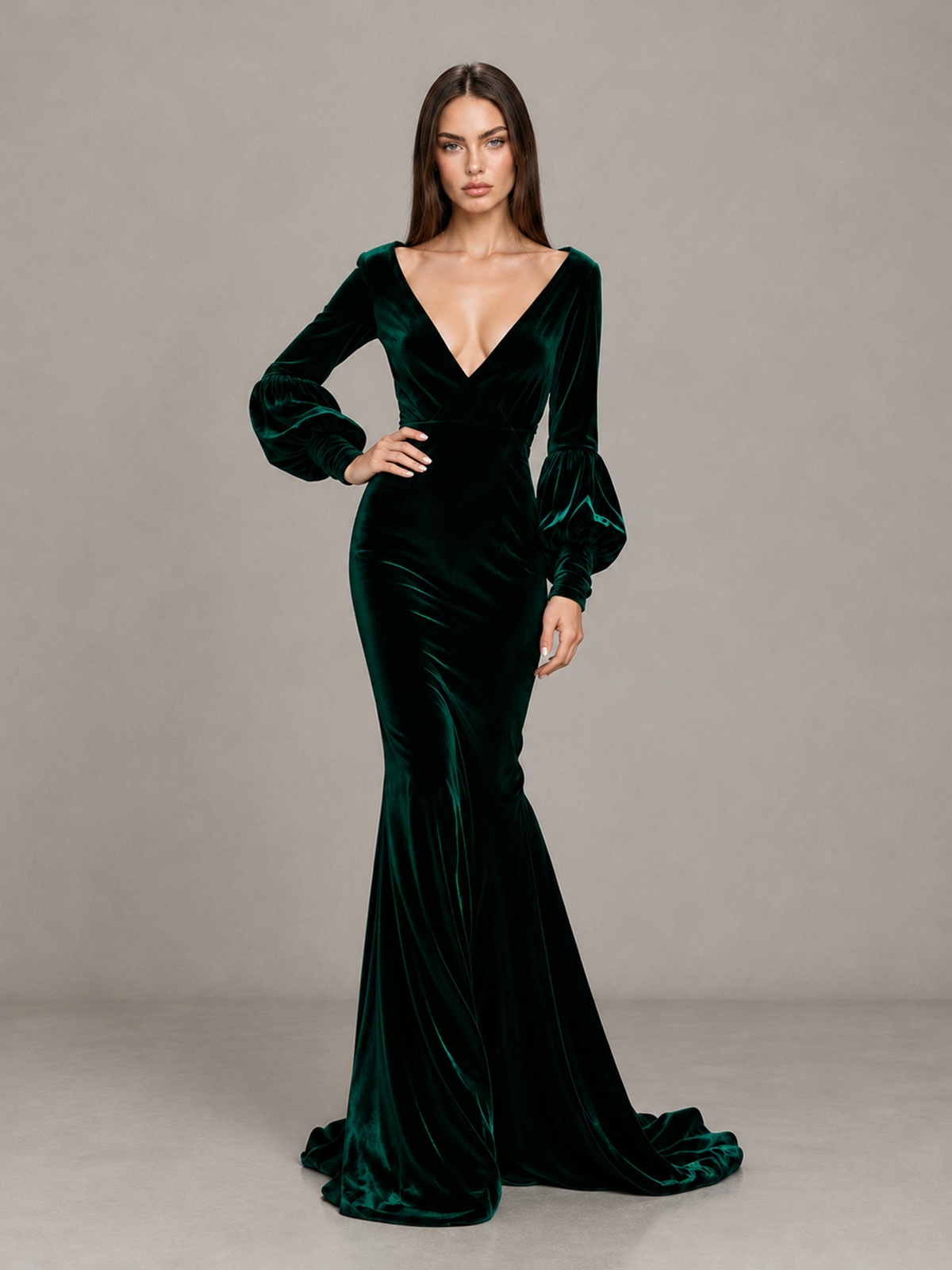 BOLODOO emerald green long sleeve mermaid gown modeled with hand on hip showing voluminous bishop sleeves