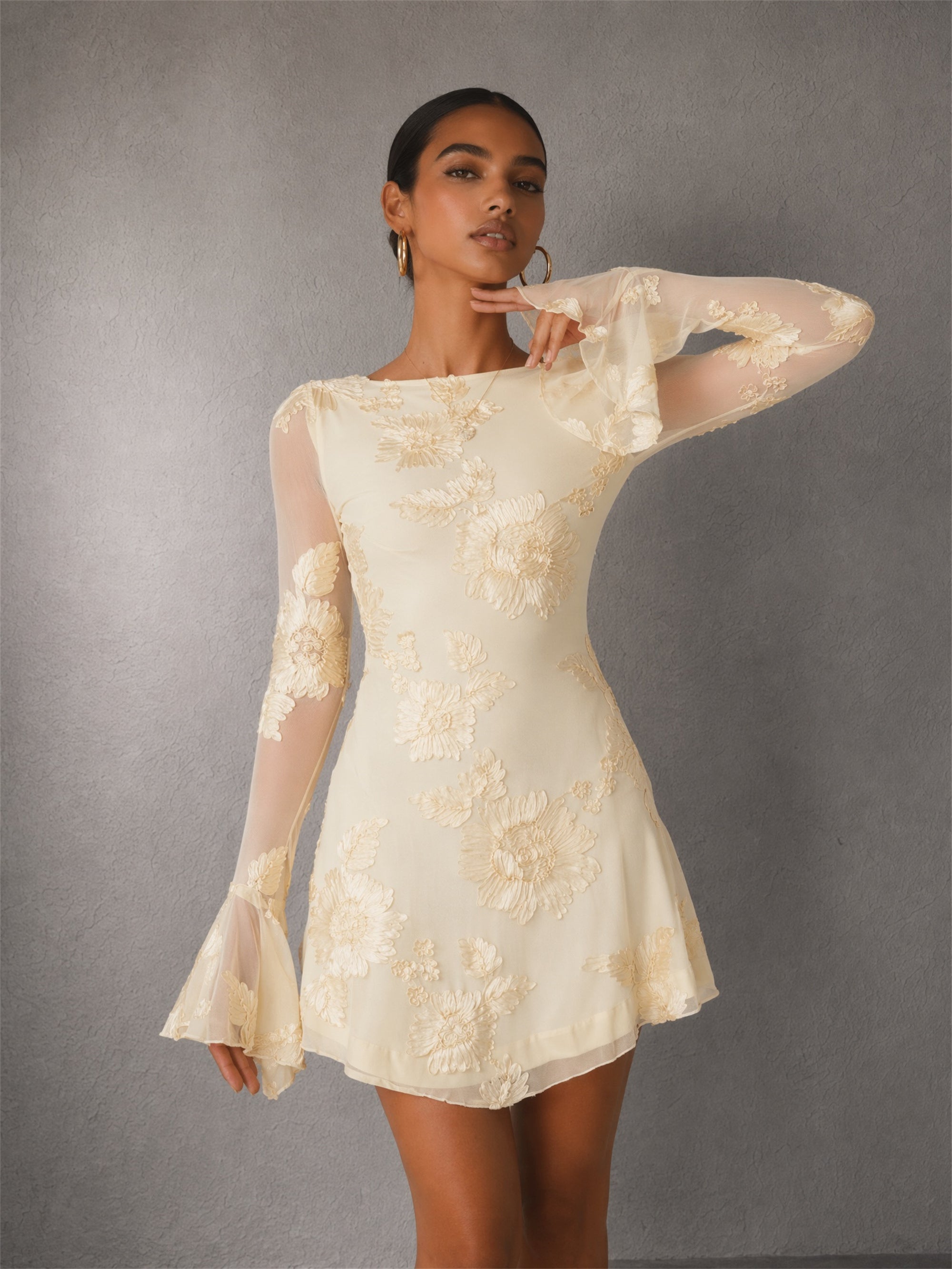 BOLODOO cream long sleeve floral embroidery mini dress - back view showing dramatic open back with tie string closure and bell sleeves