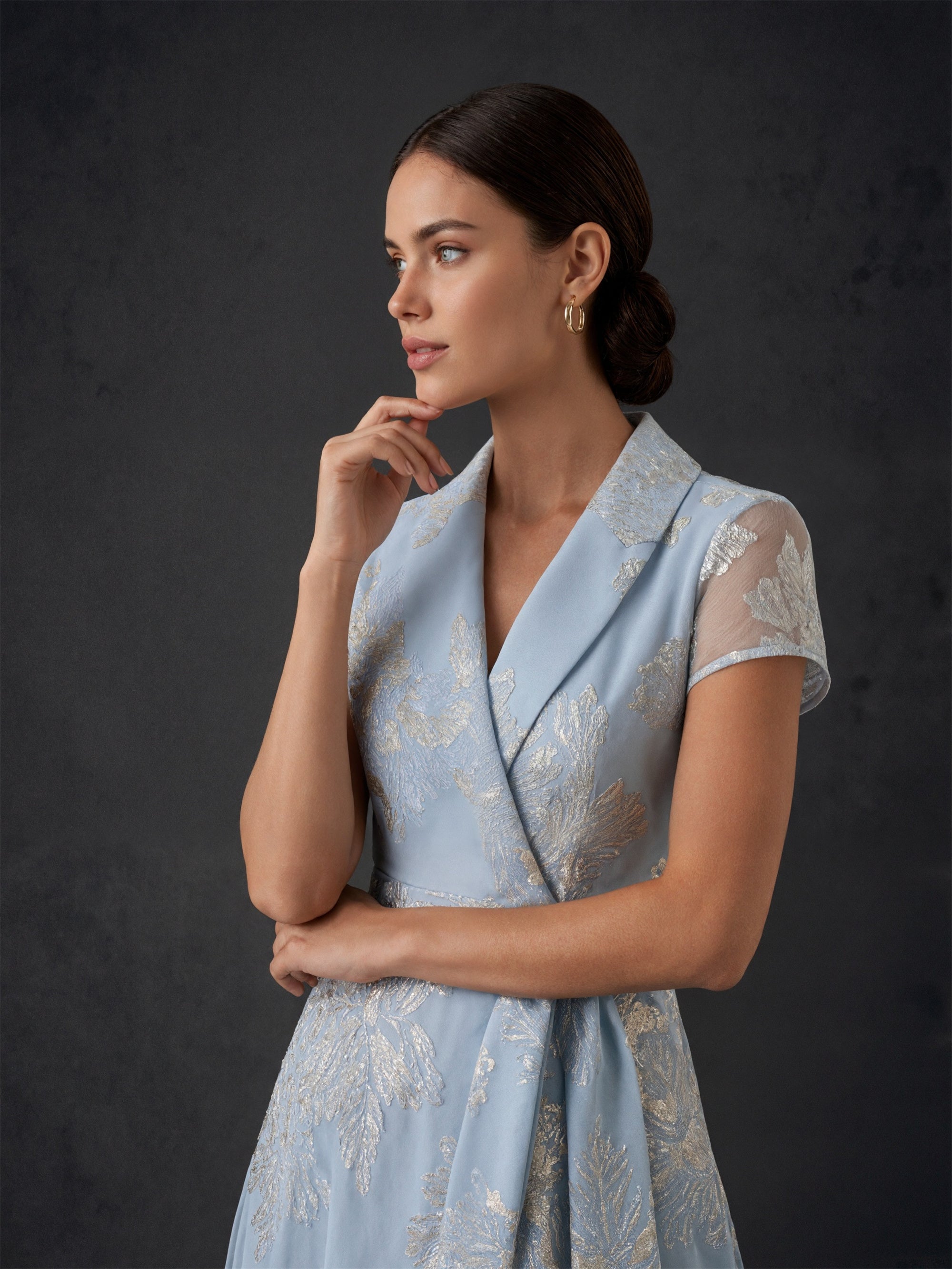 BOLODOO dusty blue metallic jacquard wrap maxi gown - front side profile upper body close-up showing sheer cap sleeve and wrap neckline