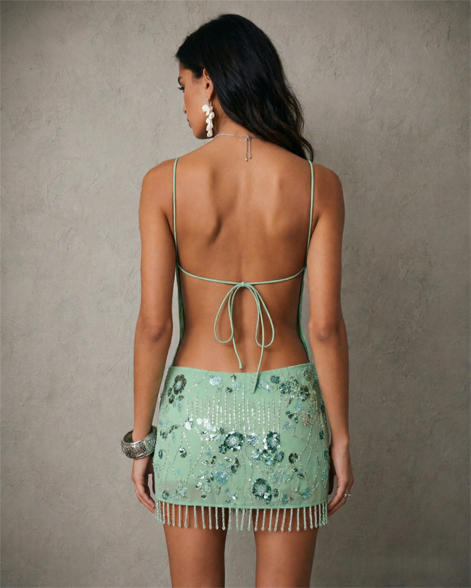 BOLODOO mint green sequin fringe mini dress - back full length view showing deep open back with tie closure and fringe hem
