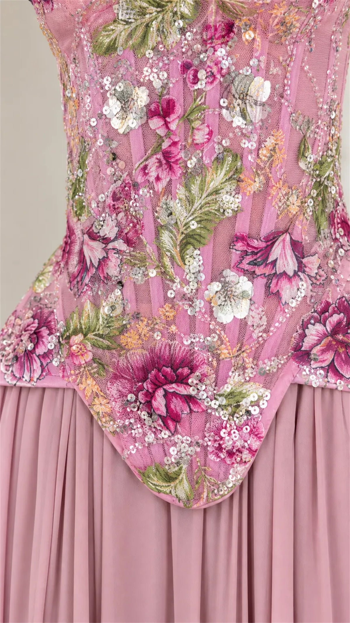 Three quarter view of pink floral beaded strapless formal dress