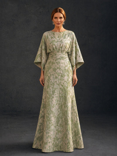 BOLODOO sage green floral brocade bateau neck batwing kimono sleeve gown close-up front view showing neckline wide batwing sleeve and ruched waistband detail