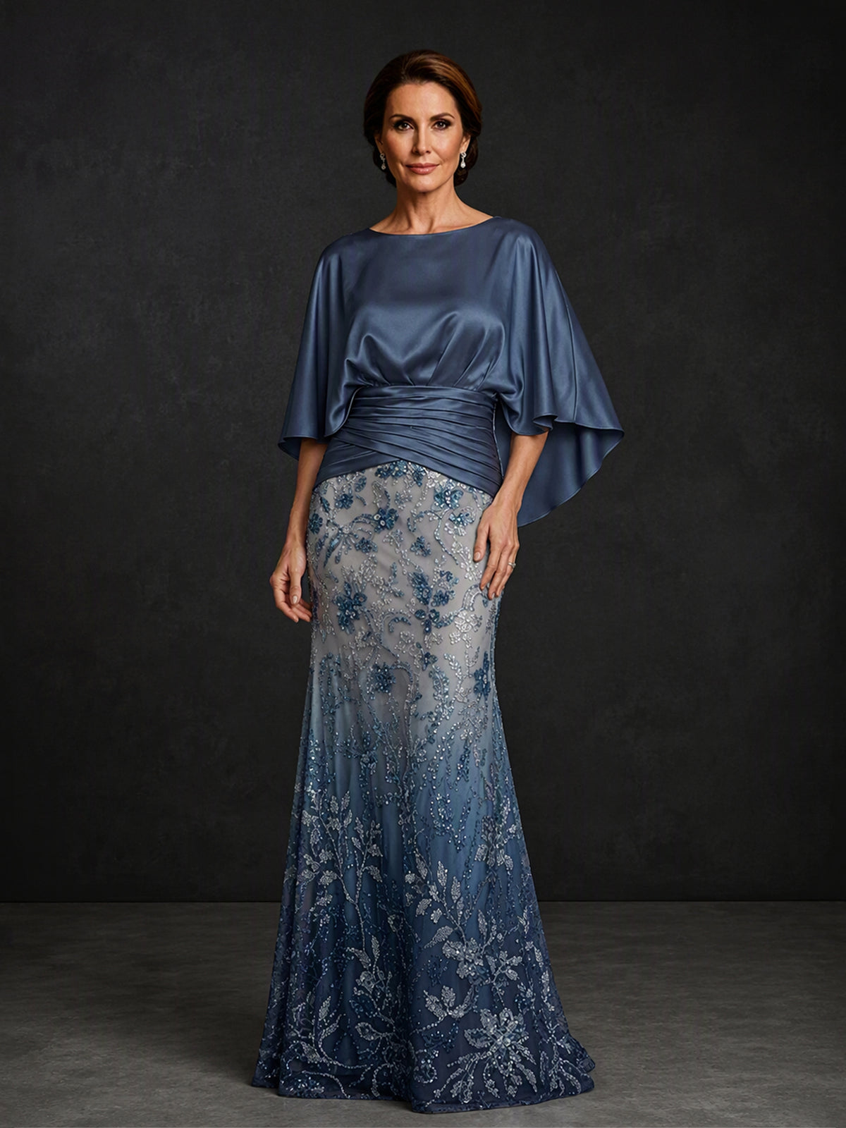 BOLODOO BX0006 steel blue mermaid gown - three-quarter side view showing cape sleeve drape, ruched waistband and ombré sequin embroidered skirt