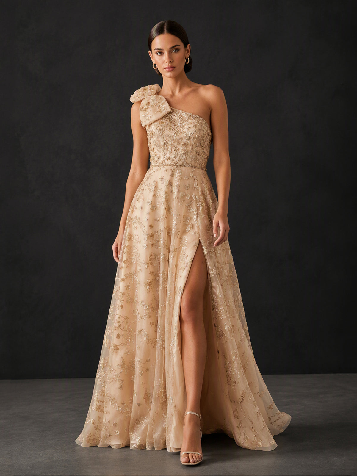 BOLODOO BX0016 champagne gold one-shoulder bow glitter lace A-line gown - full front view showing oversized organza bow, glitter lace bodice and front slit