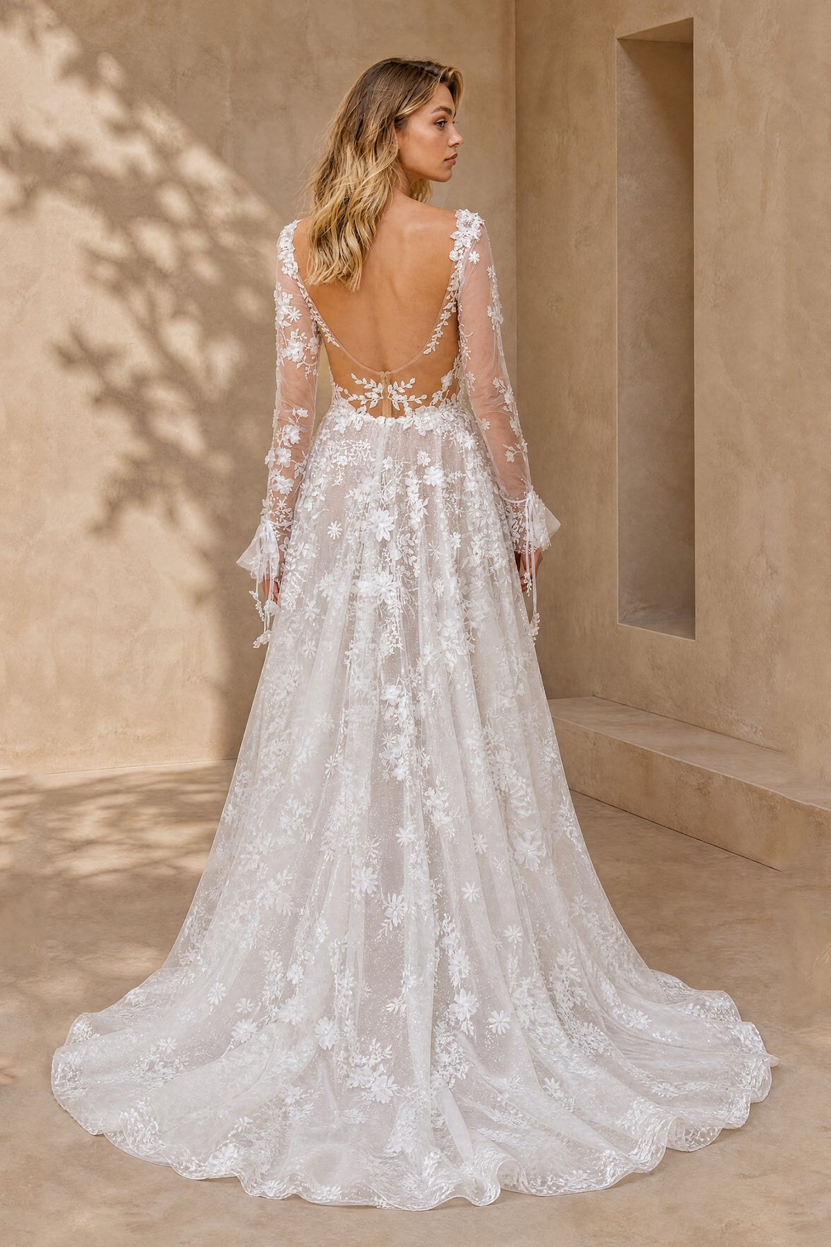 White embroidered tulle backless wedding gown with long sleeves and sweeping train