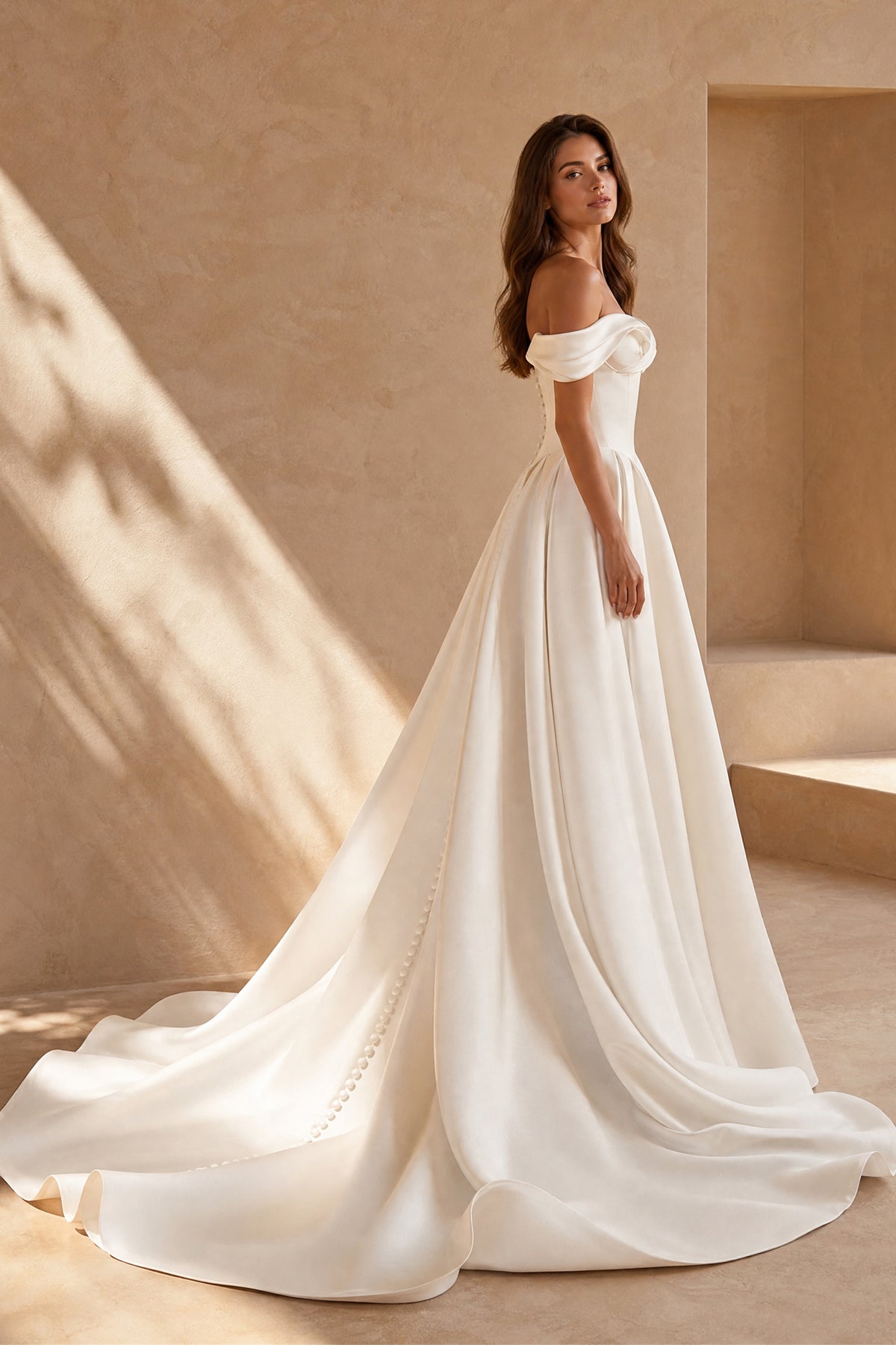 Ivory satin off shoulder bridal ball gown with covered back buttons and cathedral train