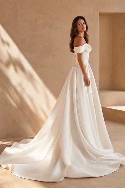 Ivory satin off shoulder bridal ball gown with covered back buttons and cathedral train