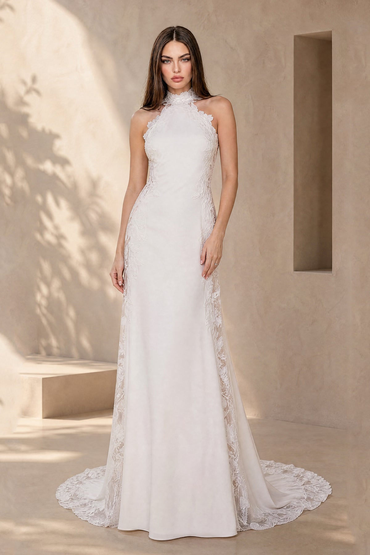 White sleeveless halter bridal gown with floral lace panels and sweep train