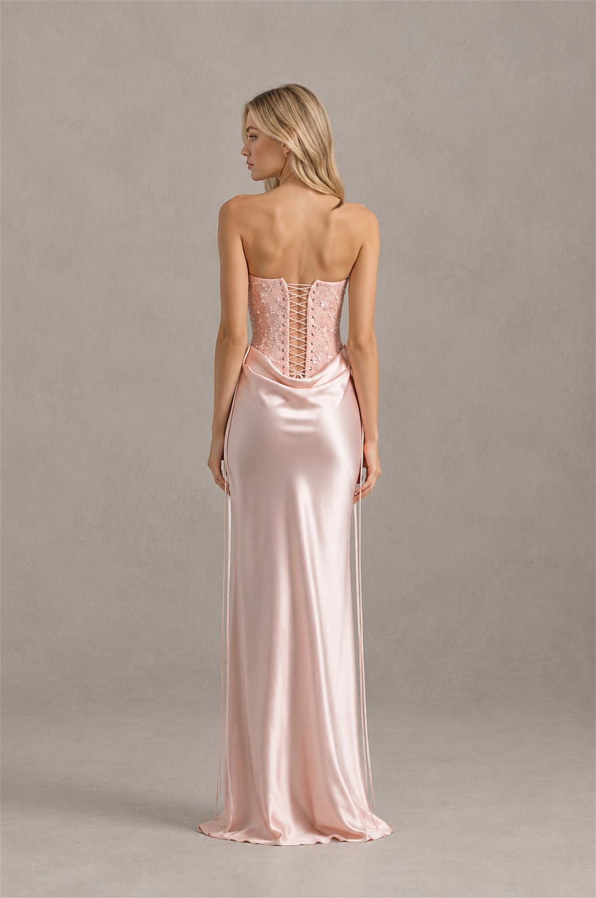 Front view of BOLODOO blush pink corset maxi dress showing flowing satin-look skirt