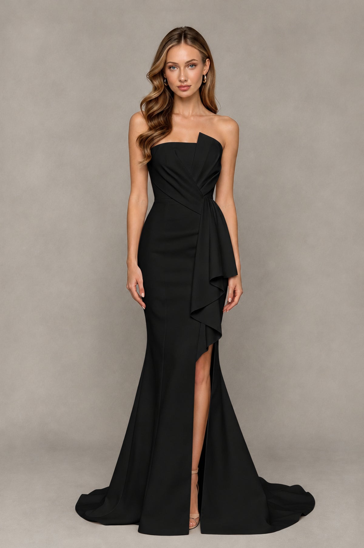 Black strapless prom dress with ruched bodice, ruffle drape and thigh-high slit, front view
