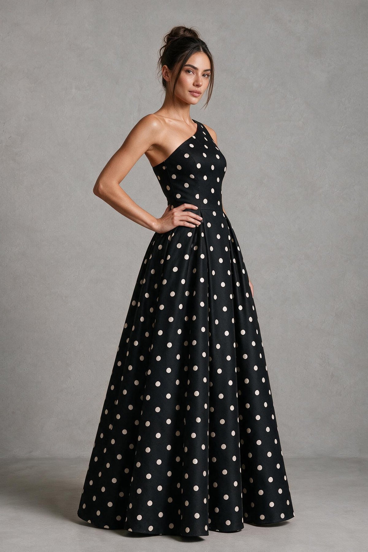 Back view of black polka dot one-shoulder maxi dress with asymmetrical back neckline