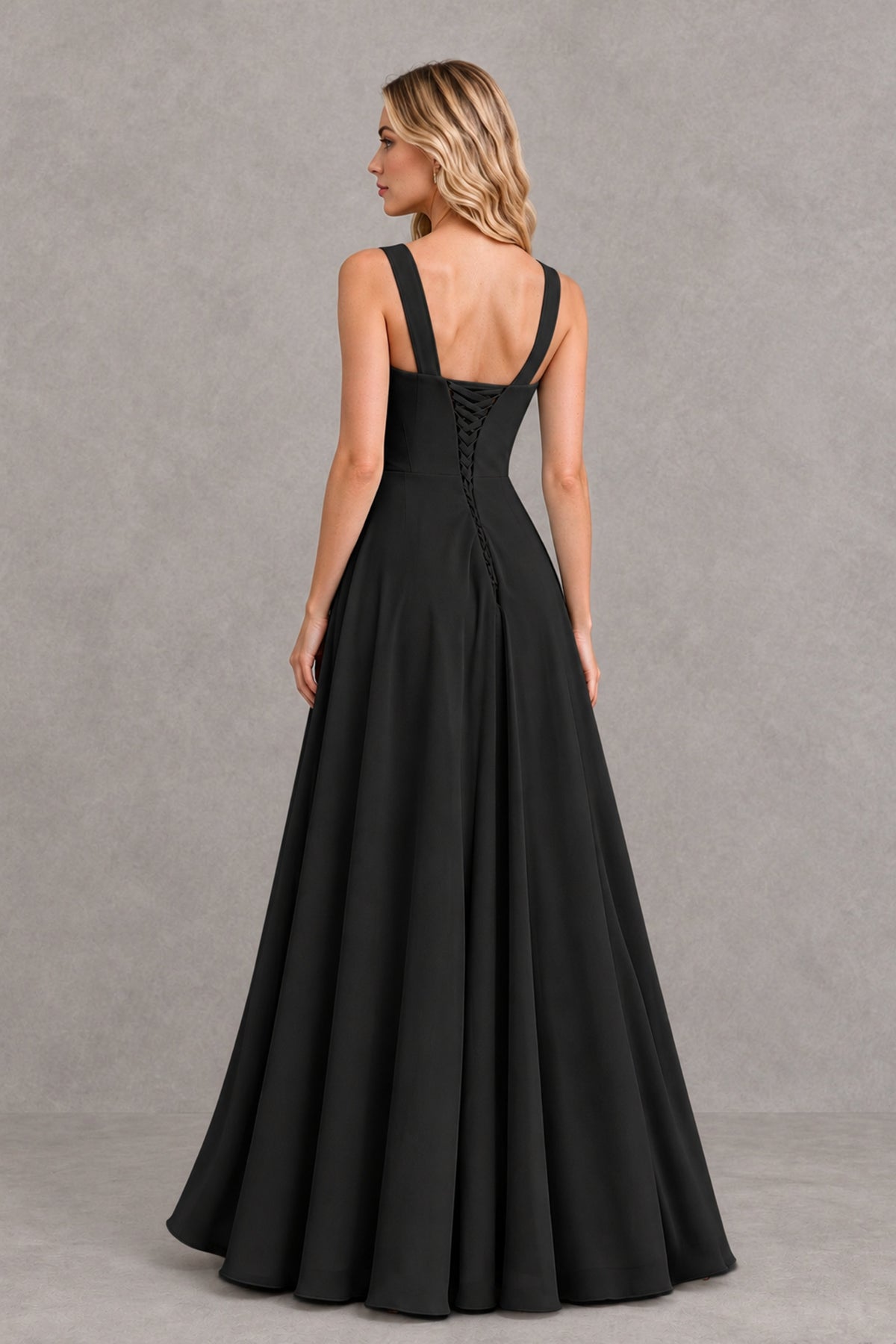 Side view of BOLODOO black sleeveless floor-length dress showing ruffled high slit