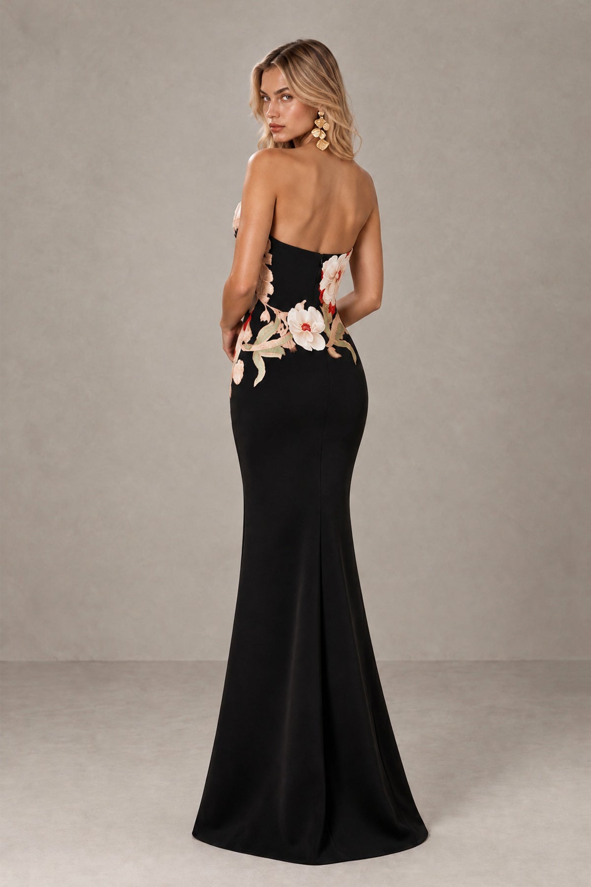Back view of BOLODOO black strapless evening gown with exposed upper back and multicolor floral detailing