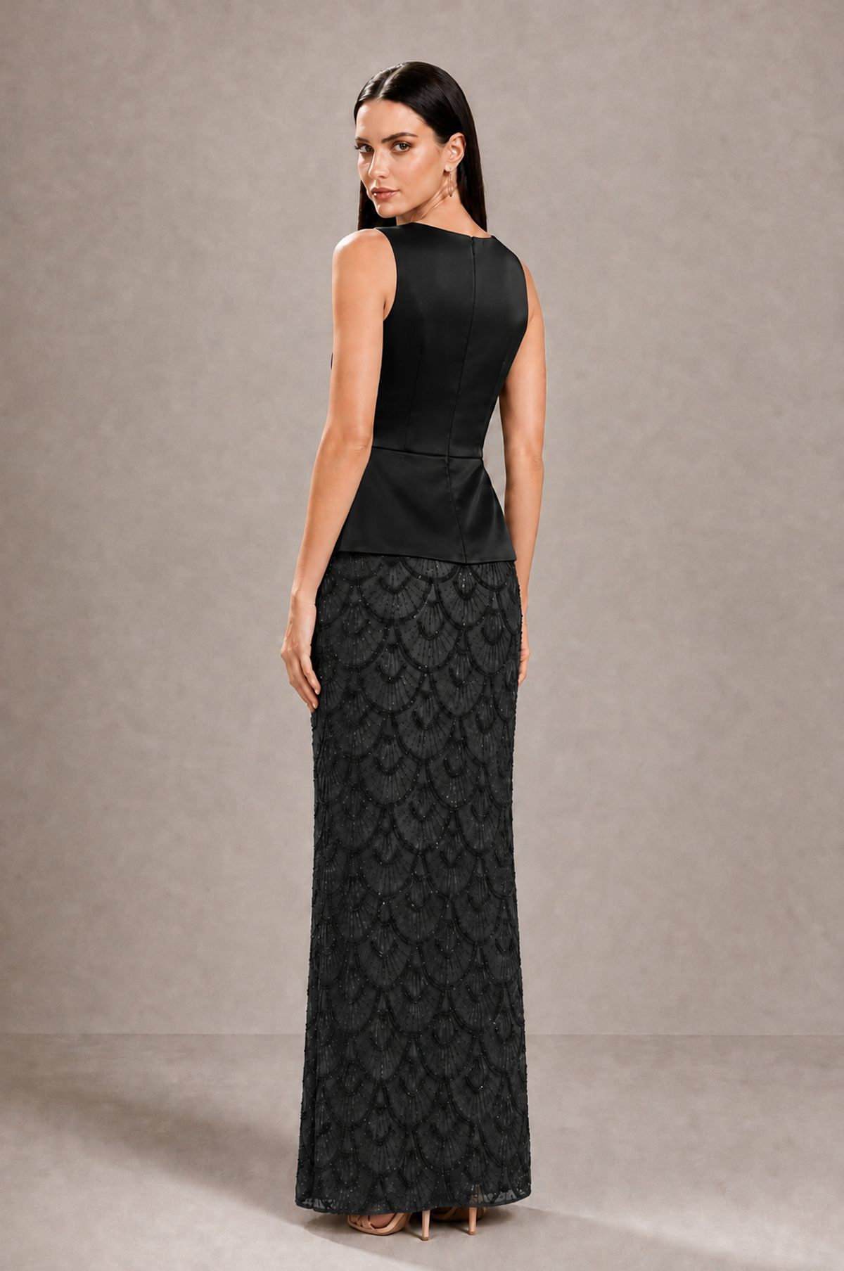 Back view of BOLODOO black sleeveless evening dress showing covered back and center-back zipper