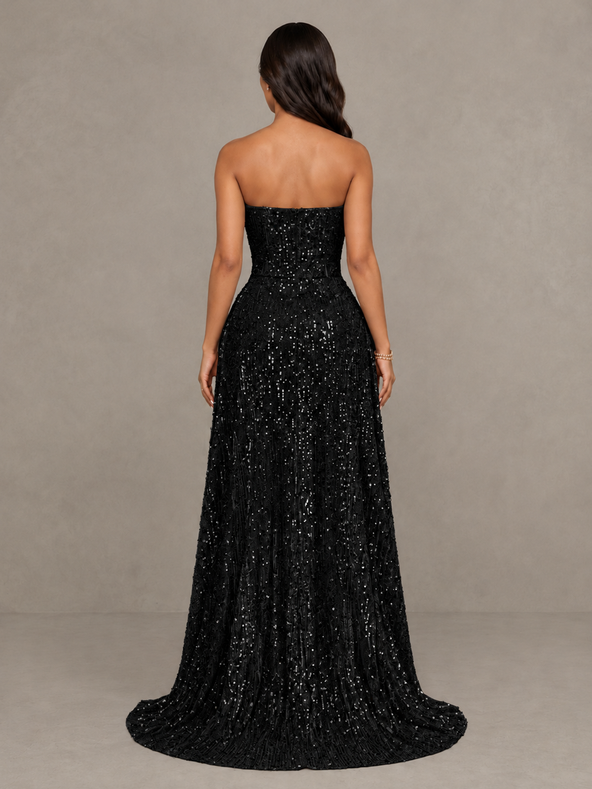 Side view of the black sequin strapless dress with high low train