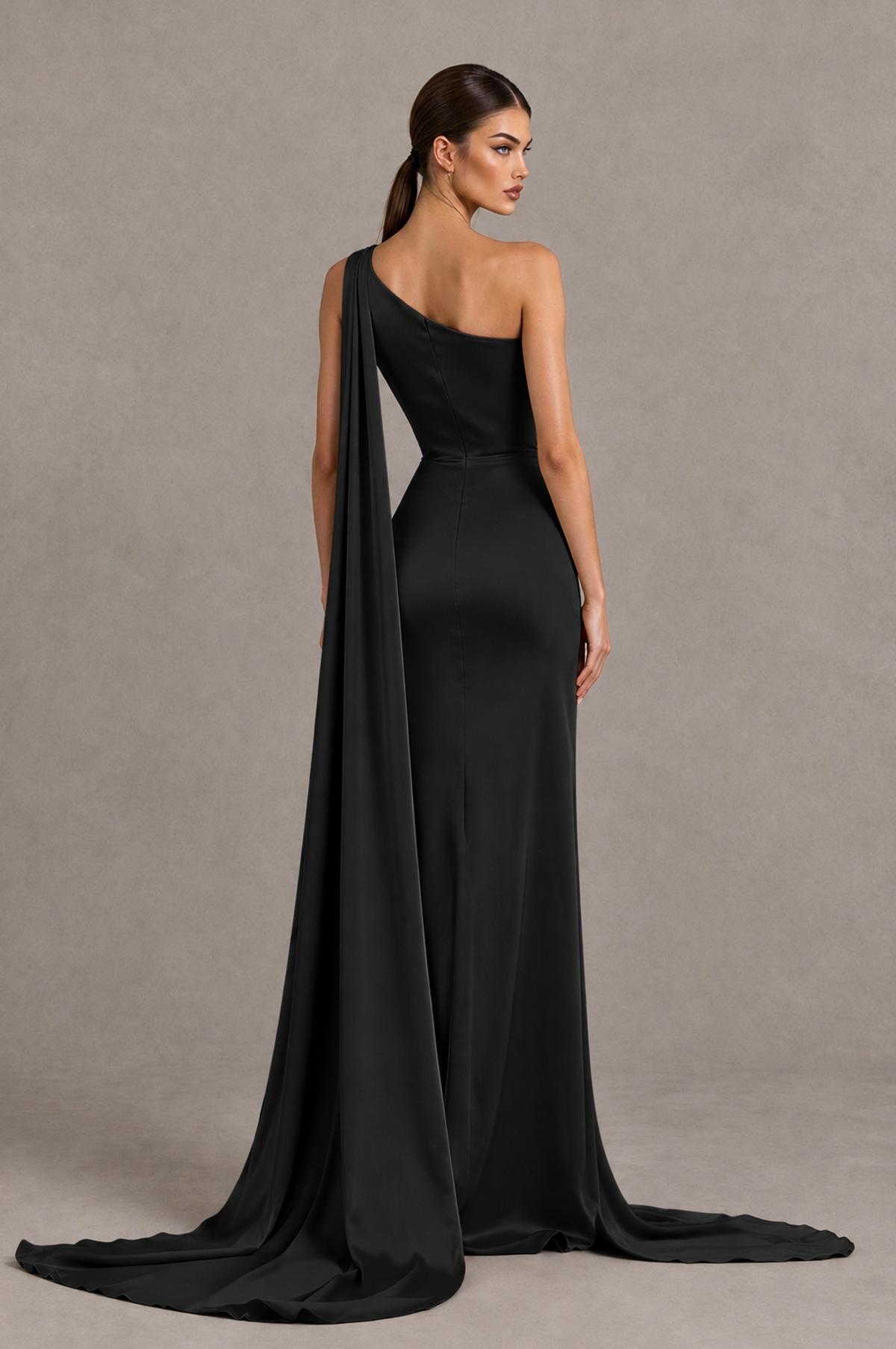 Black one shoulder satin formal gown with covered back and sweeping drape train, back view