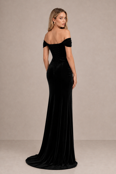 Back view of BOLODOO black velvet evening gown showing exposed upper back and gently trailing hem