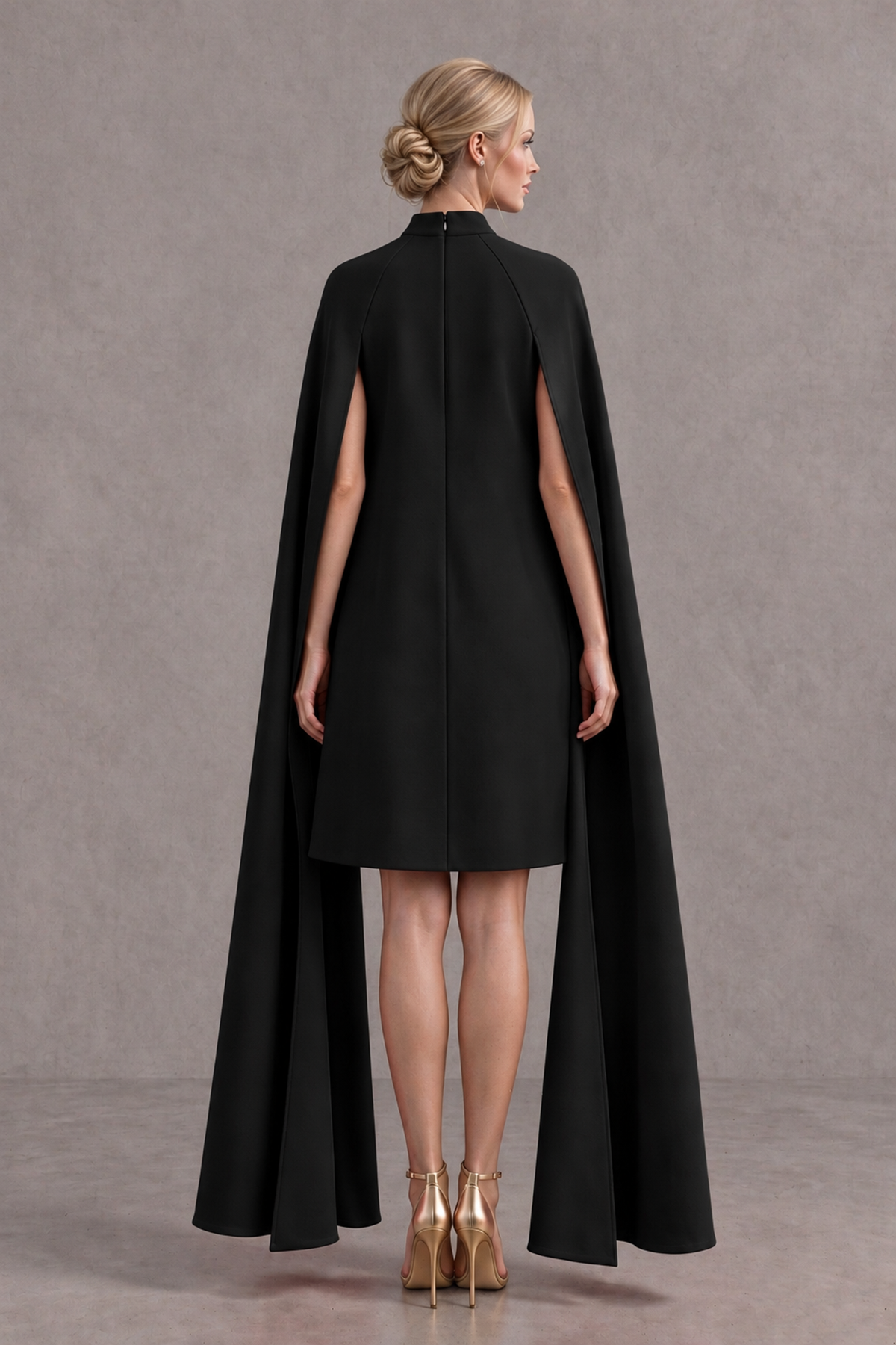 Back view of BOLODOO black cape mini dress with covered back and center-back zipper