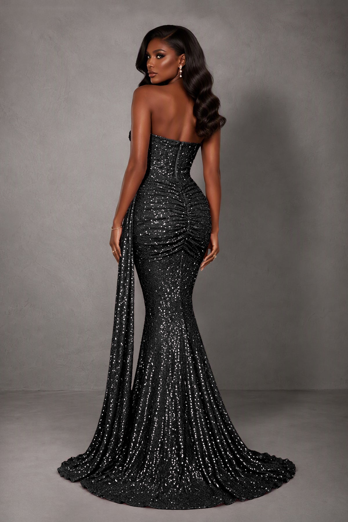 BOLODOO black sequin mermaid gown, back view showing exposed upper back, ruching and train