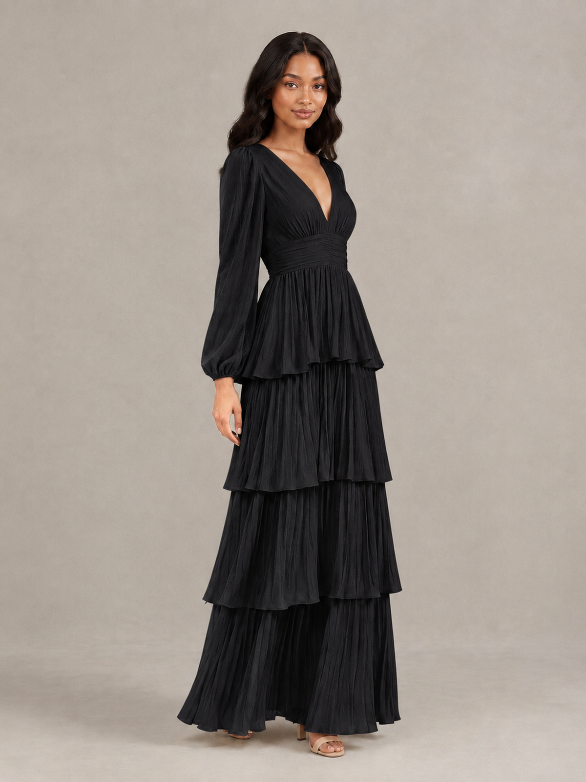 Three-quarter view of BOLODOO black long-sleeve pleated tiered maxi dress
